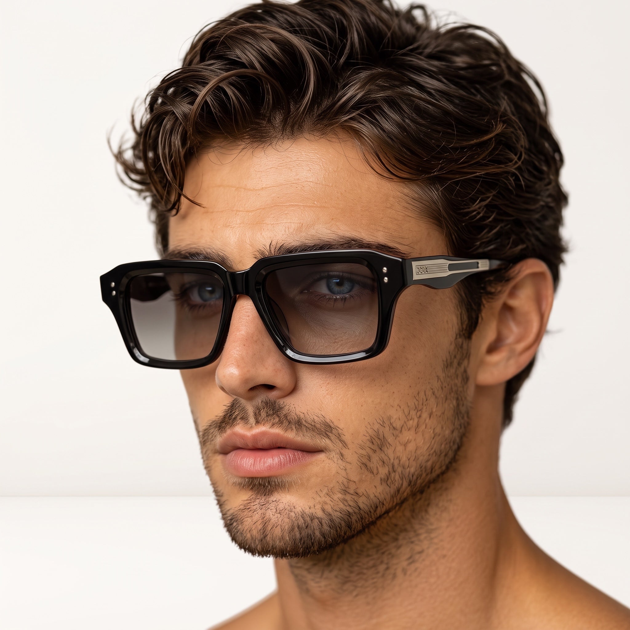 Close-up of man wearing black square Celine sunglasses with metal temple detail
