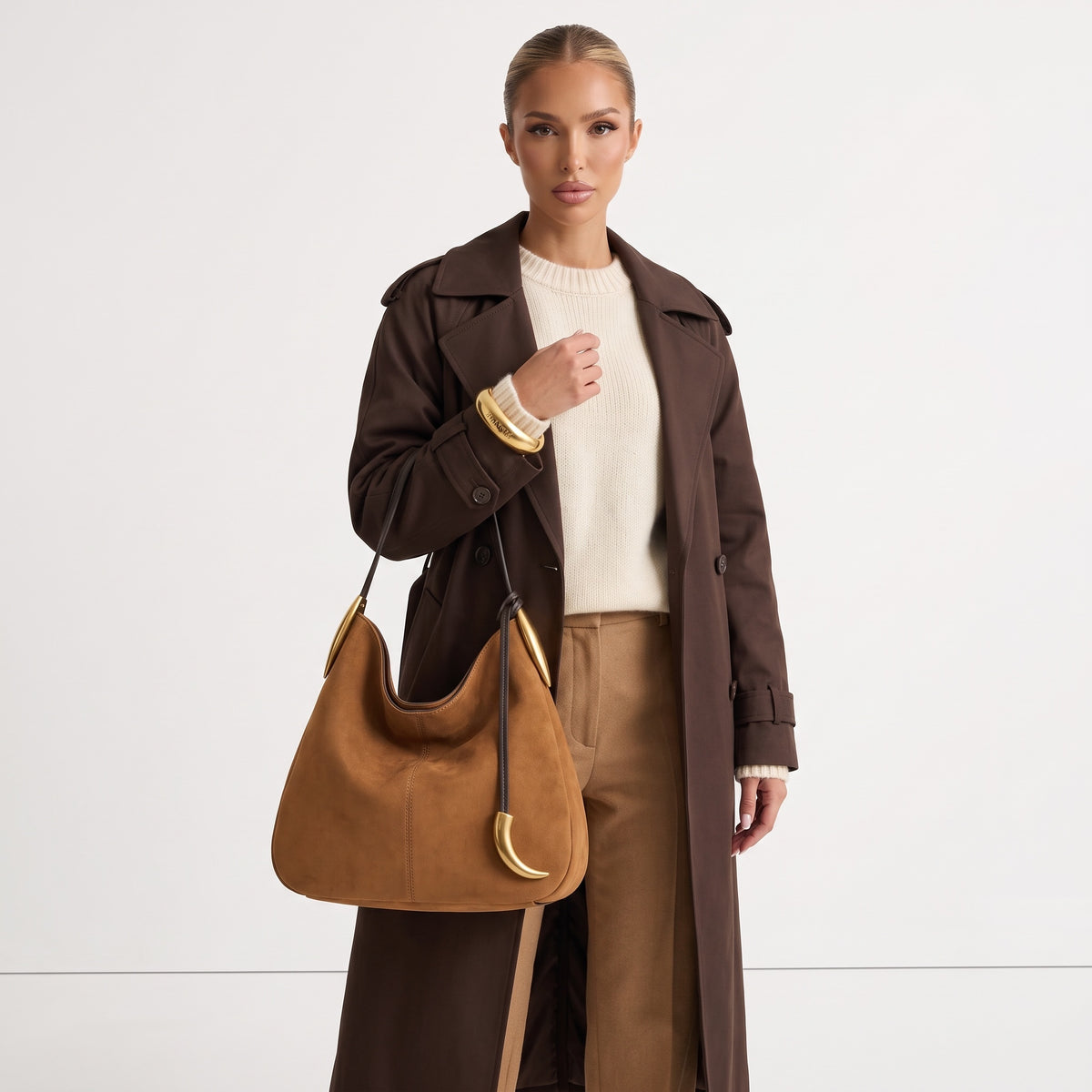 tan hobo bag with gold crescent hardware and single shoulder strap