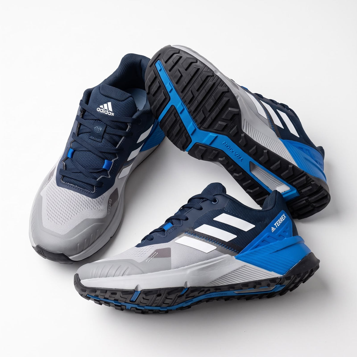 Adidas Terrex navy grey trail running shoe with blue accents showing outsole and upper