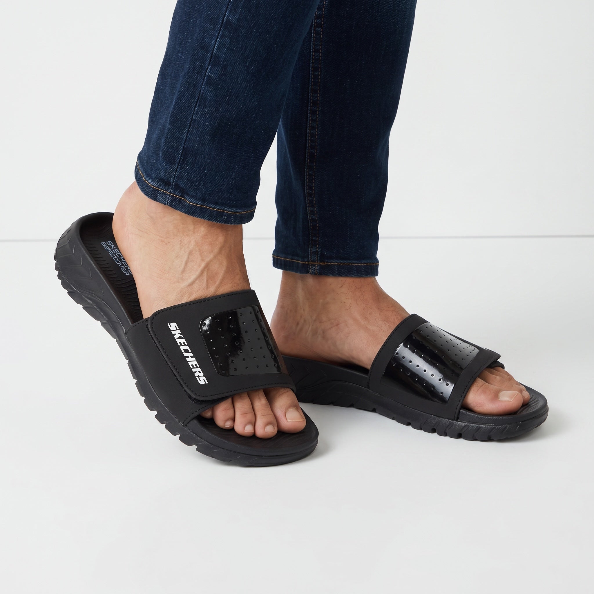 black Skechers men's slide with adjustable perforated strap and cushioned sole