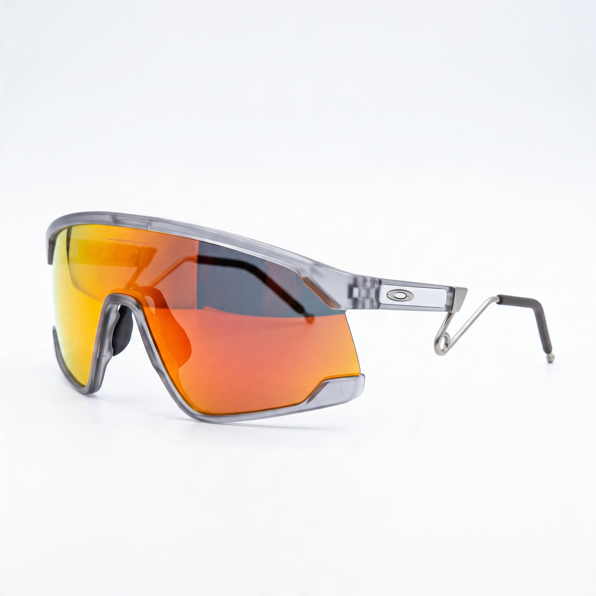 Oakley wrap shield sunglasses with orange mirrored lens and translucent grey frame.
