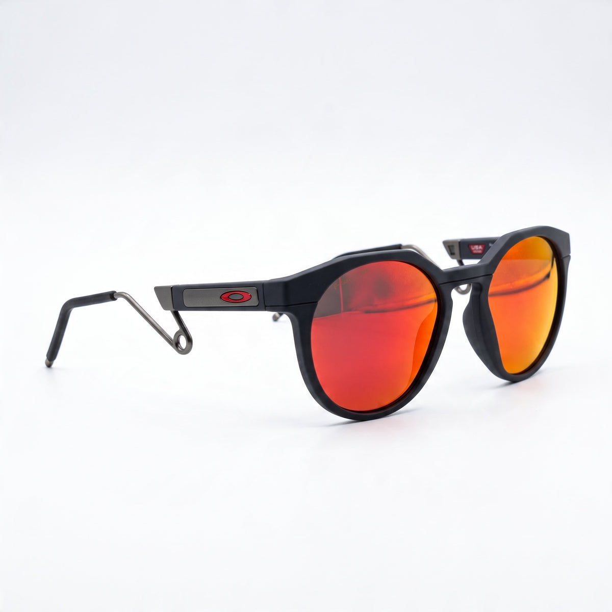 Oakley black frame sunglasses with red mirror lenses and metal wire temples