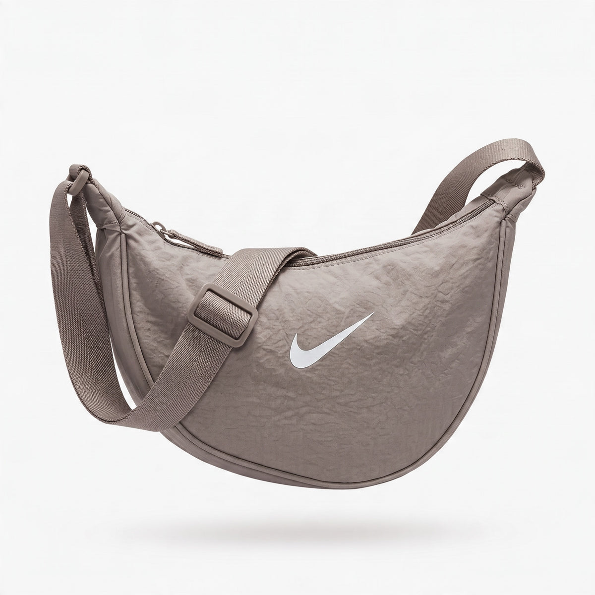 taupe Nike crescent crossbody bag with adjustable webbing strap and white swoosh