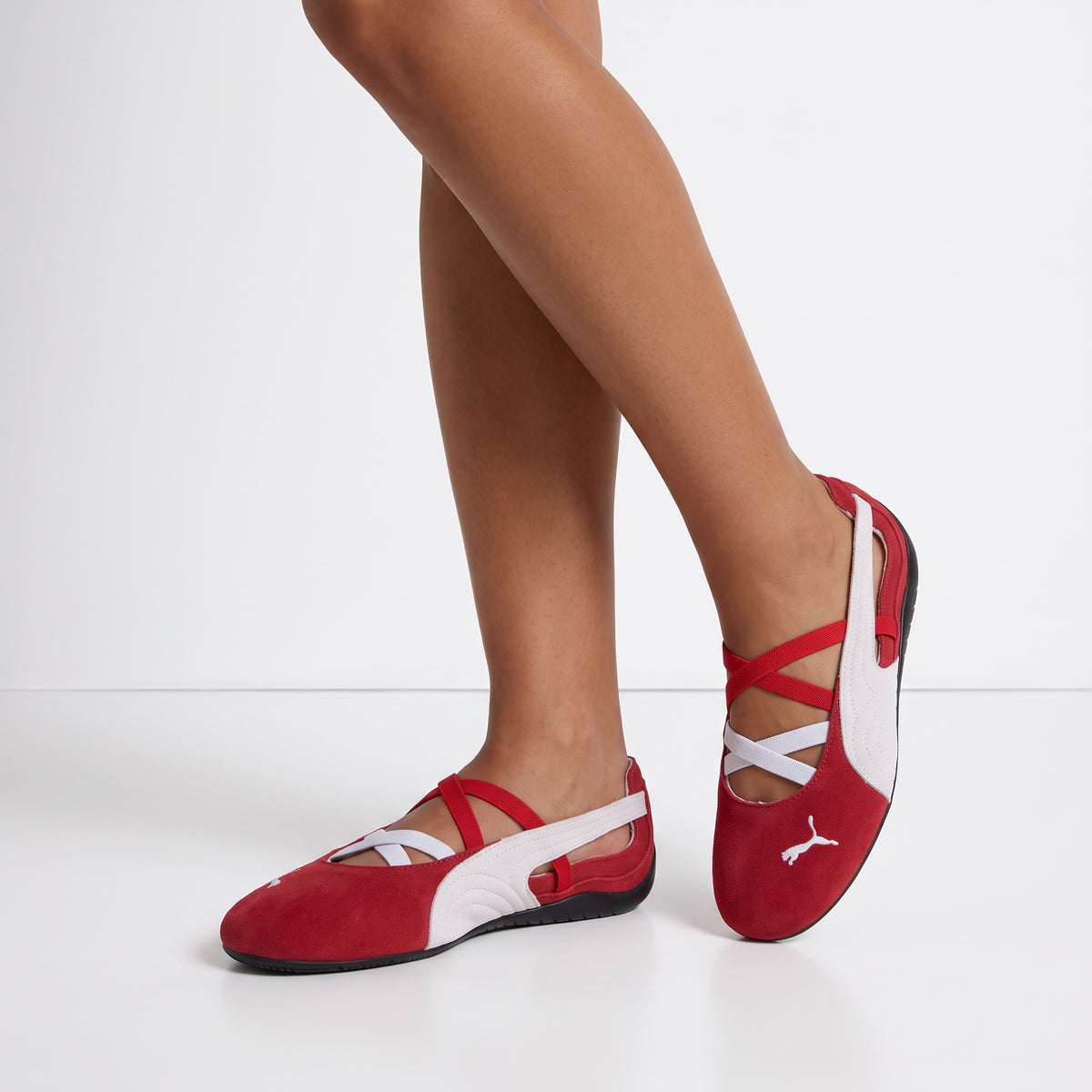 Red and white Puma ballet flats with criss-cross straps