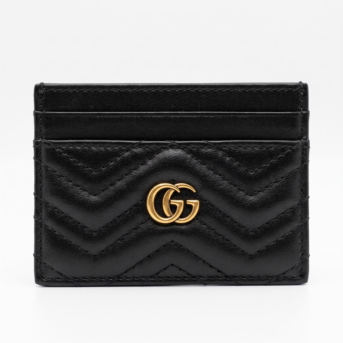 black quilted Gucci card holder with gold double G logo