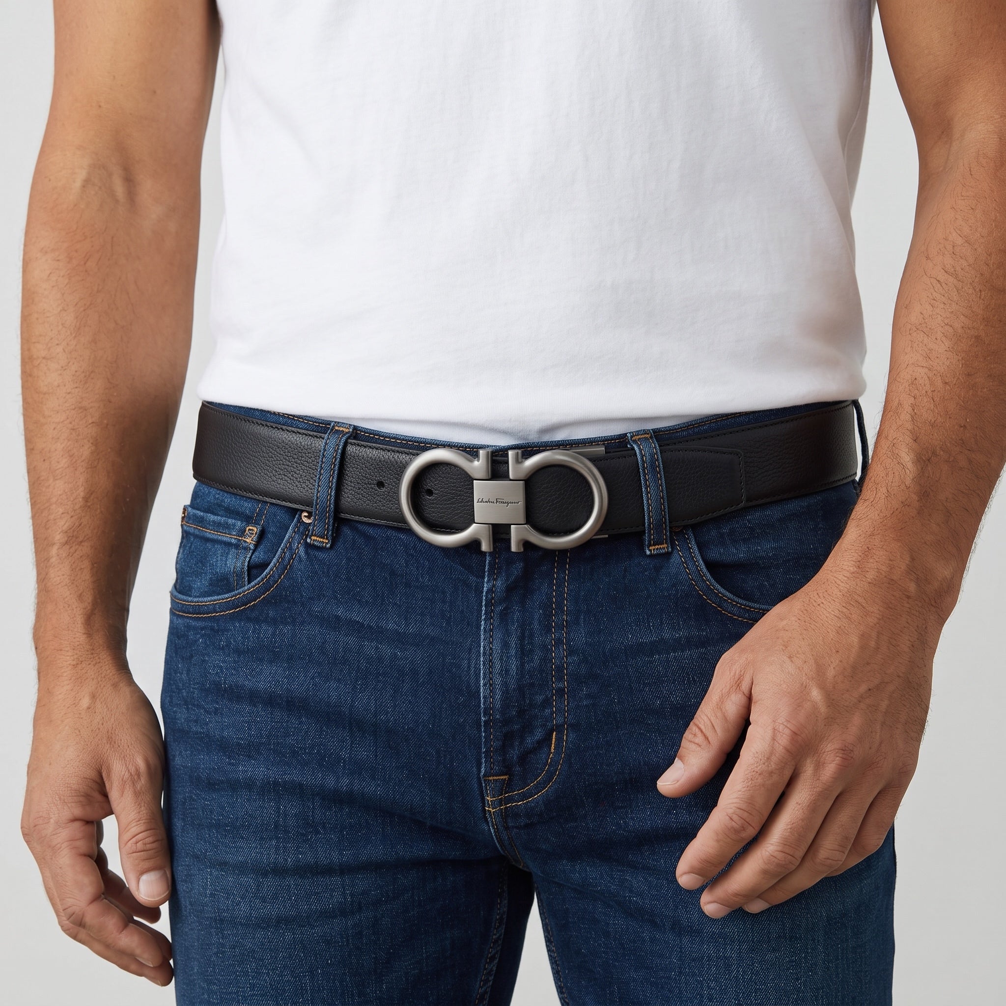 Black Salvatore Ferragamo belt with Gancini double-ring buckle worn with jeans
