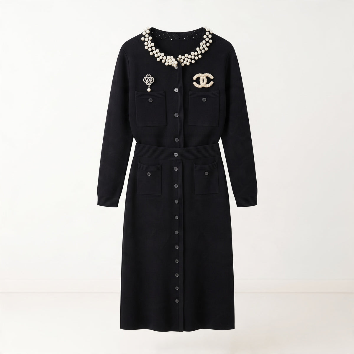 black Chanel cardigan with pearl collar and decorative brooches