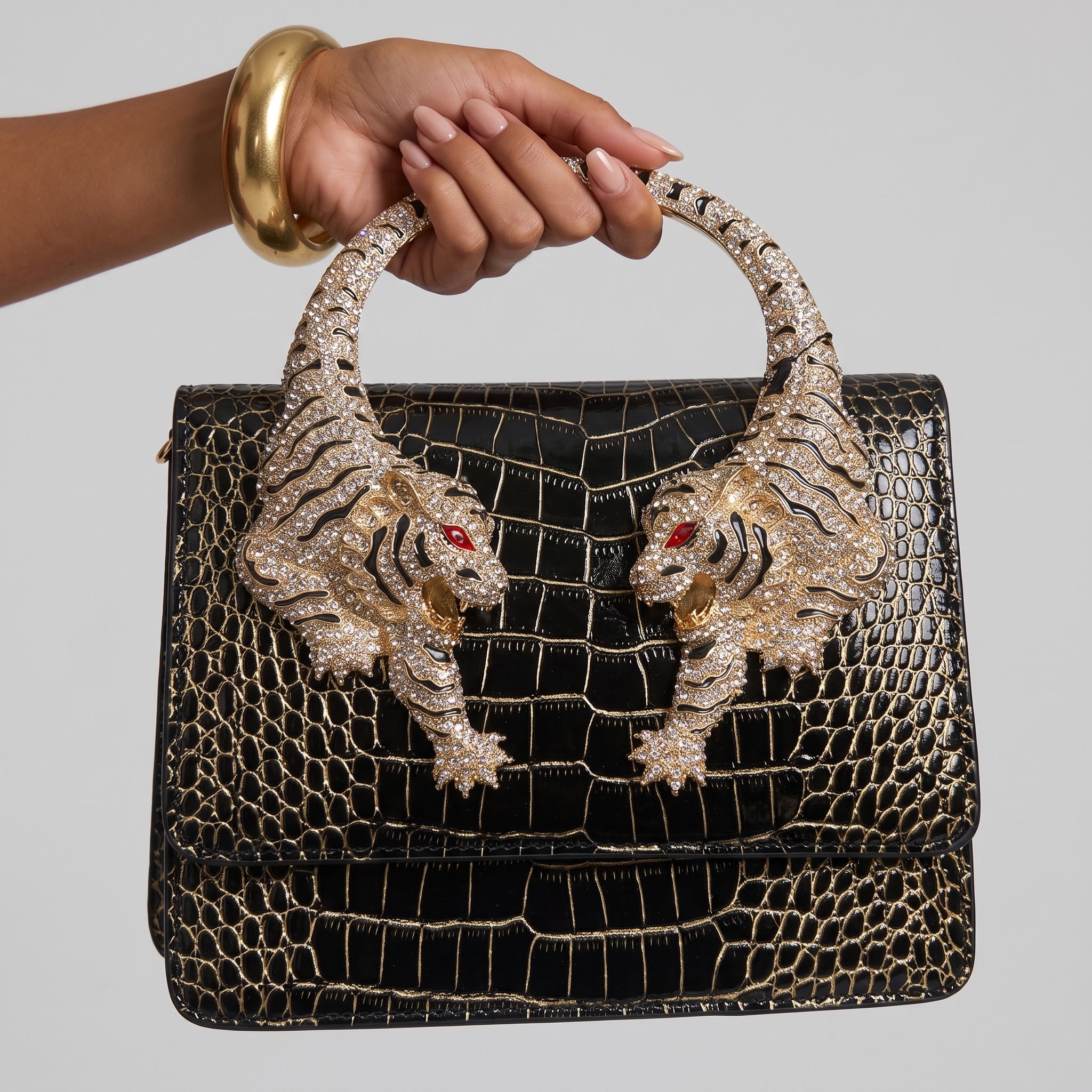 black croc-effect top-handle bag with gold tiger-head circular handle and crystal detail