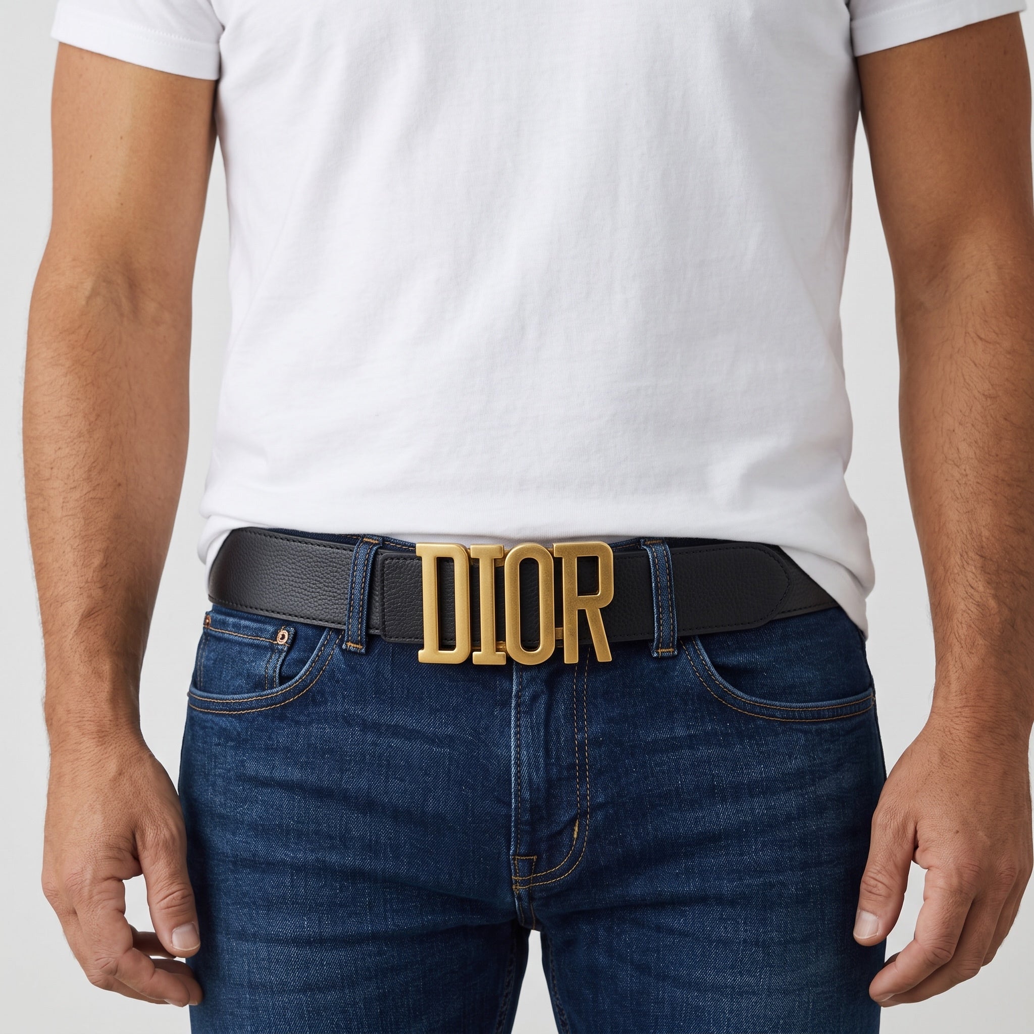 Black Dior belt with large gold DIOR buckle worn with jeans