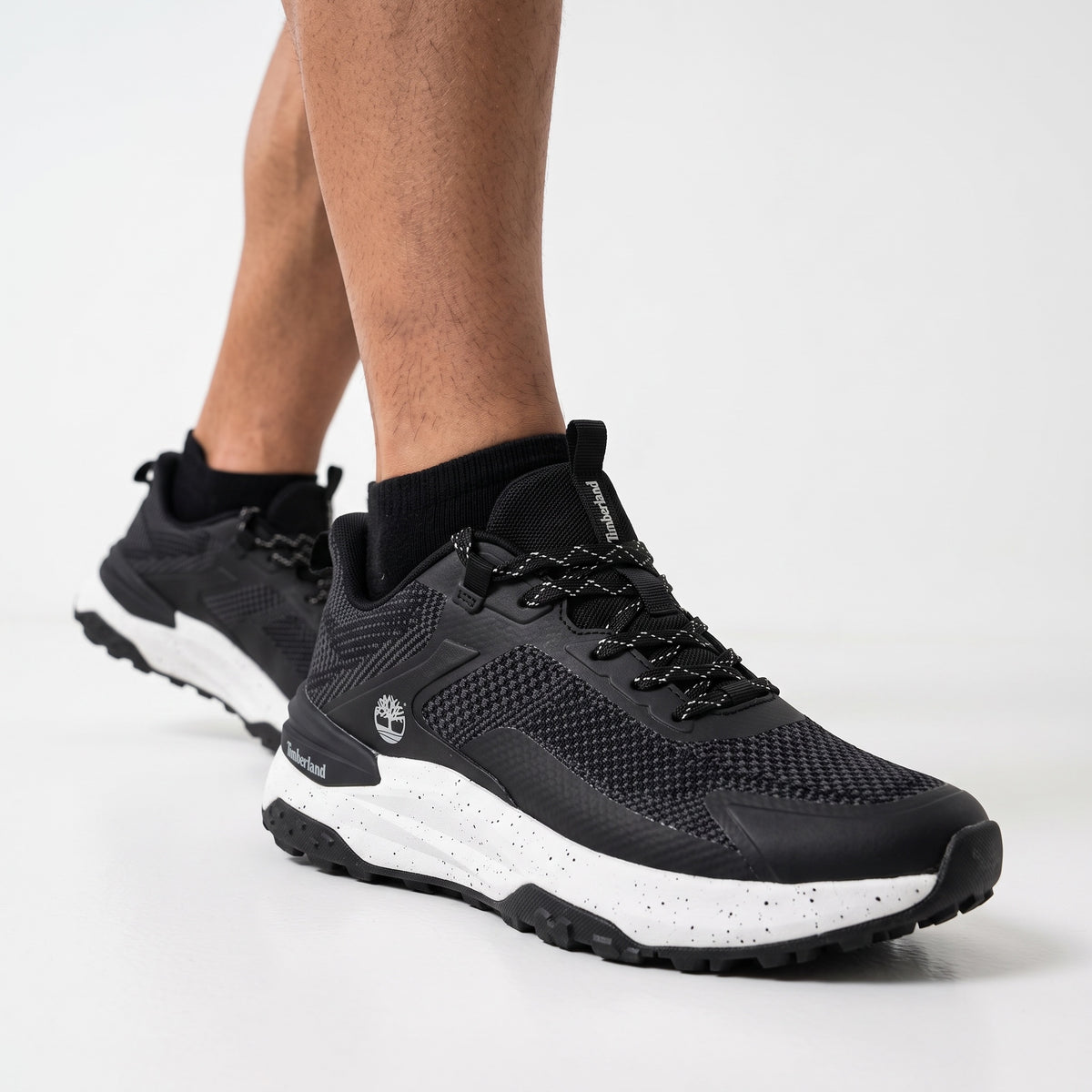 Black Timberland low-top trail sneakers with speckled white midsole