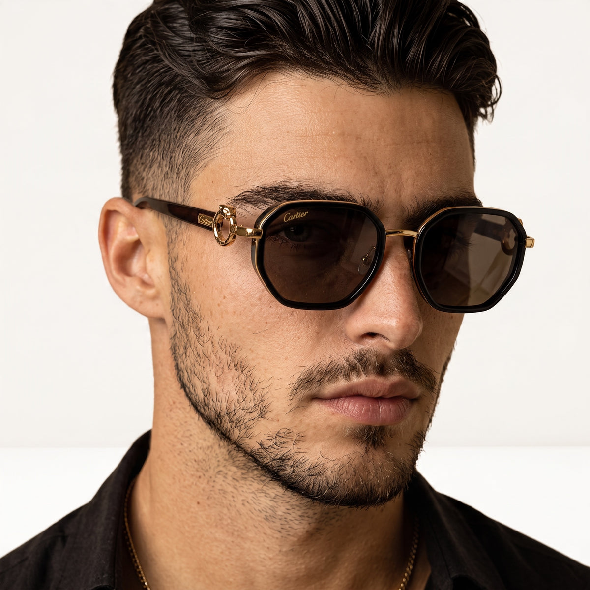 Close-up Cartier sunglasses with tortoiseshell frame and gold panther detail