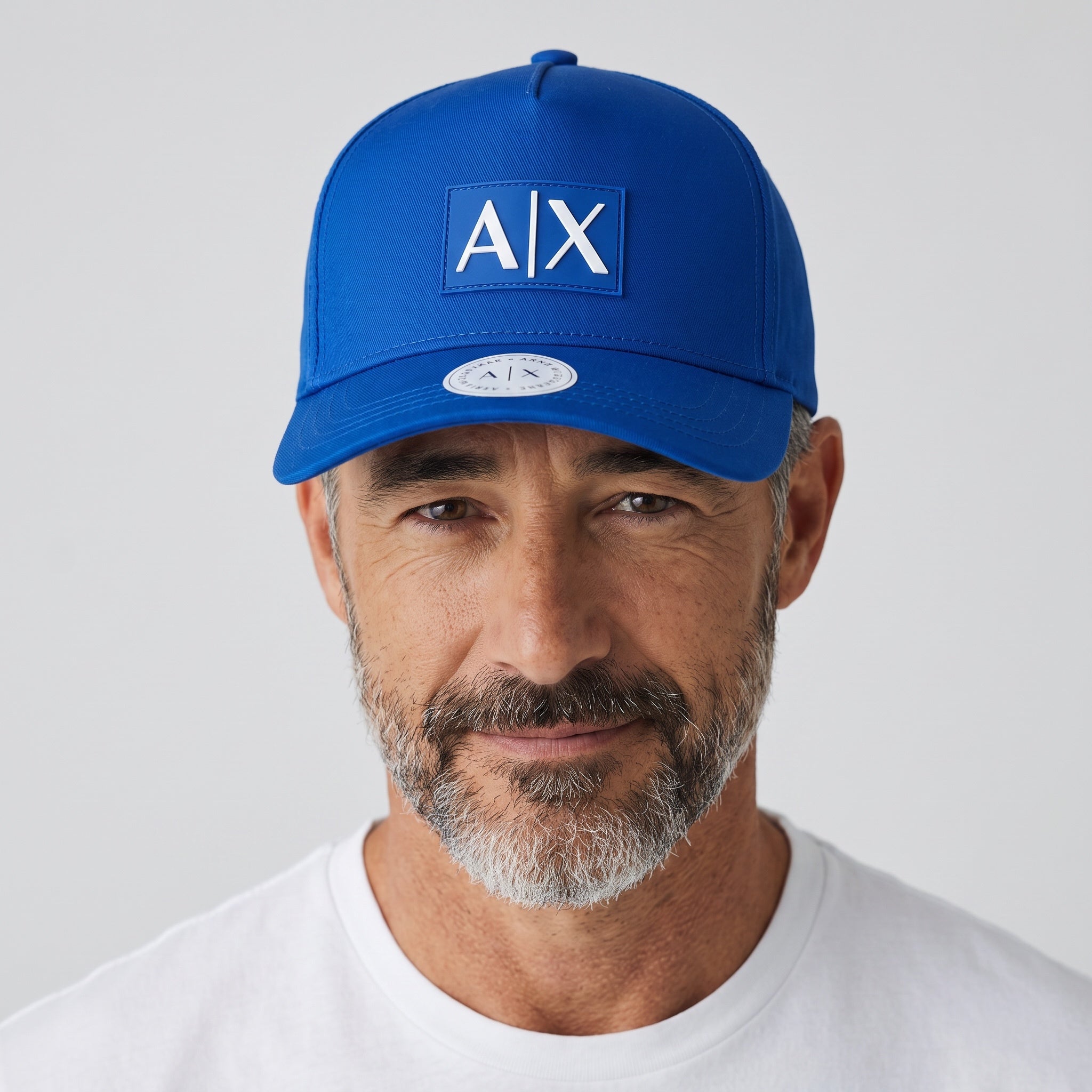 Man wearing a royal blue Armani Exchange AX baseball cap with logo patch