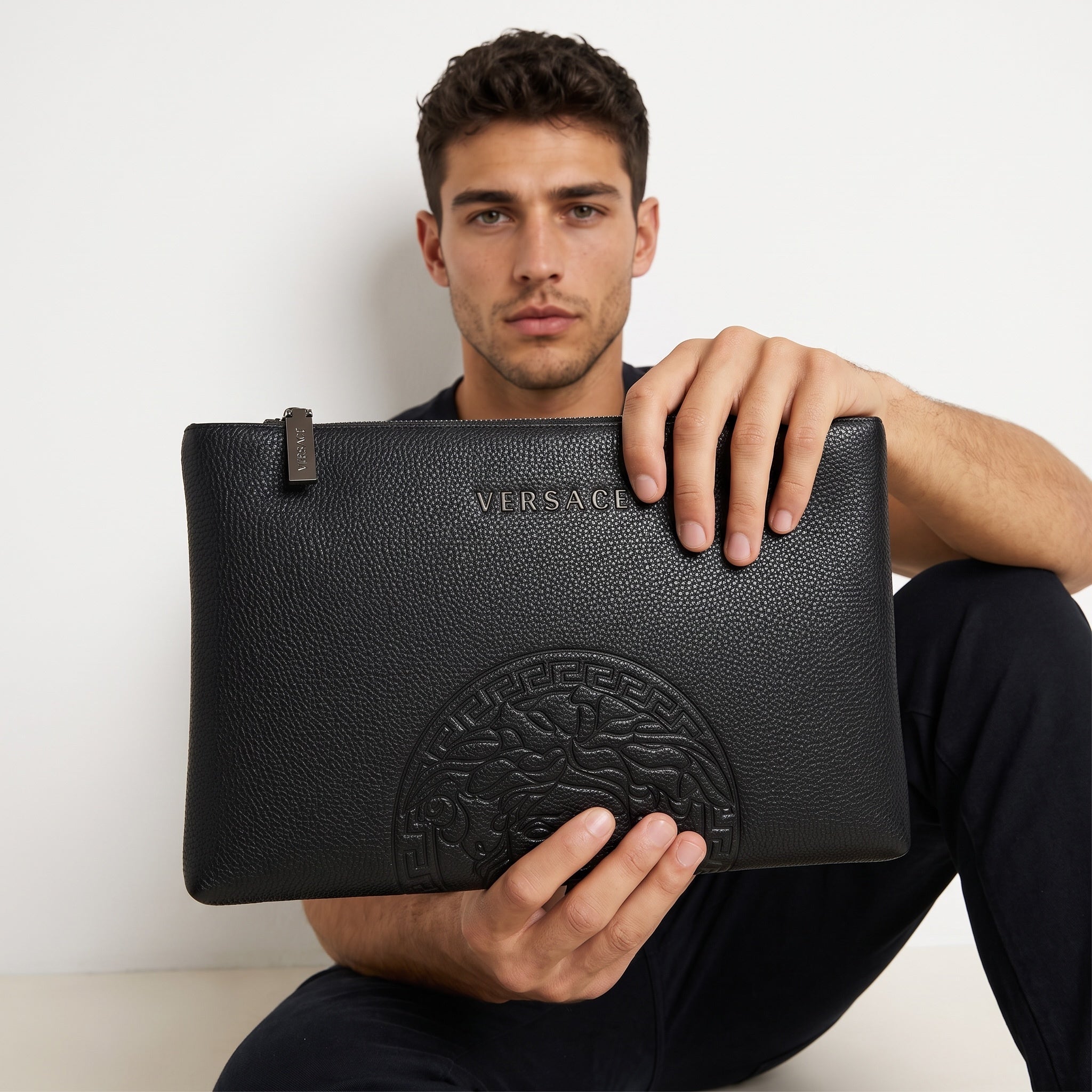 Black Versace textured clutch with embossed Medusa and metal logo pull