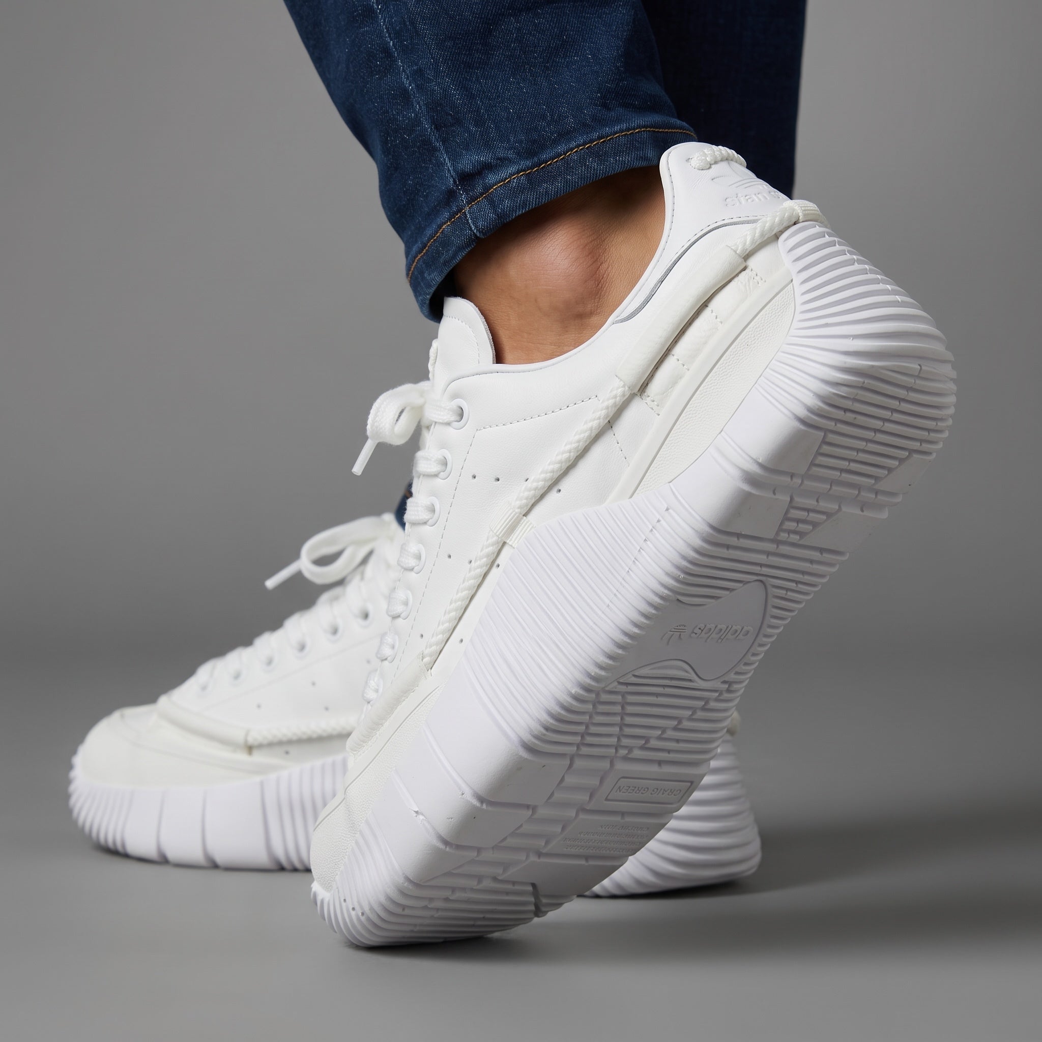 All-white Adidas Stan Smith low-top sneakers with chunky ribbed sole and rope detail