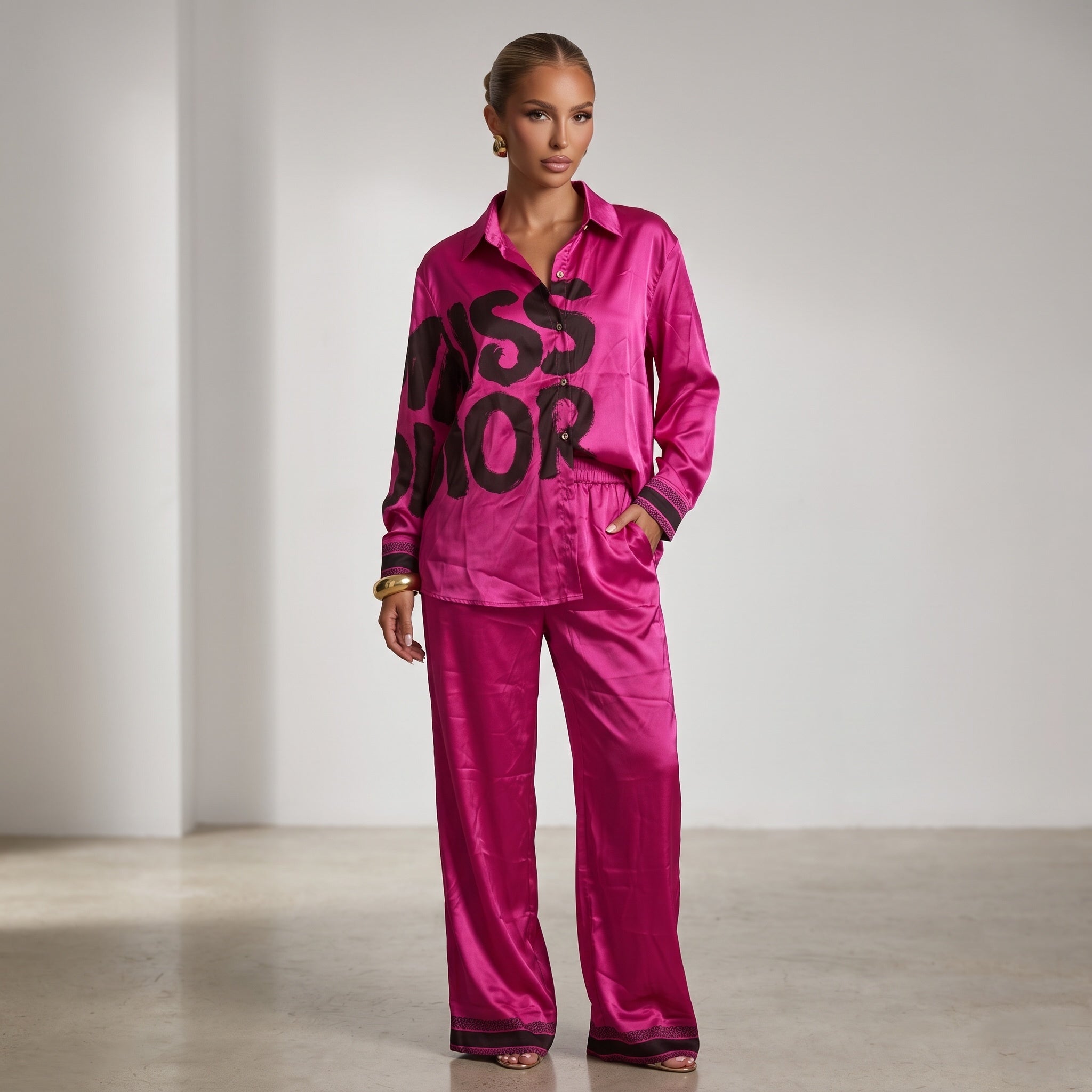 Fuchsia longline button-down shirt with black graphic lettering