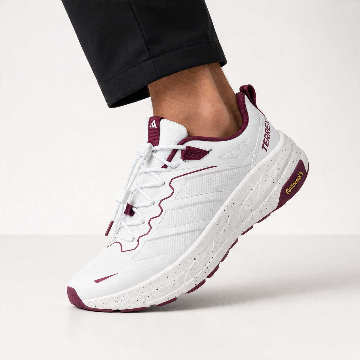 Adidas Terrex white sneaker with maroon accents and speckled midsole