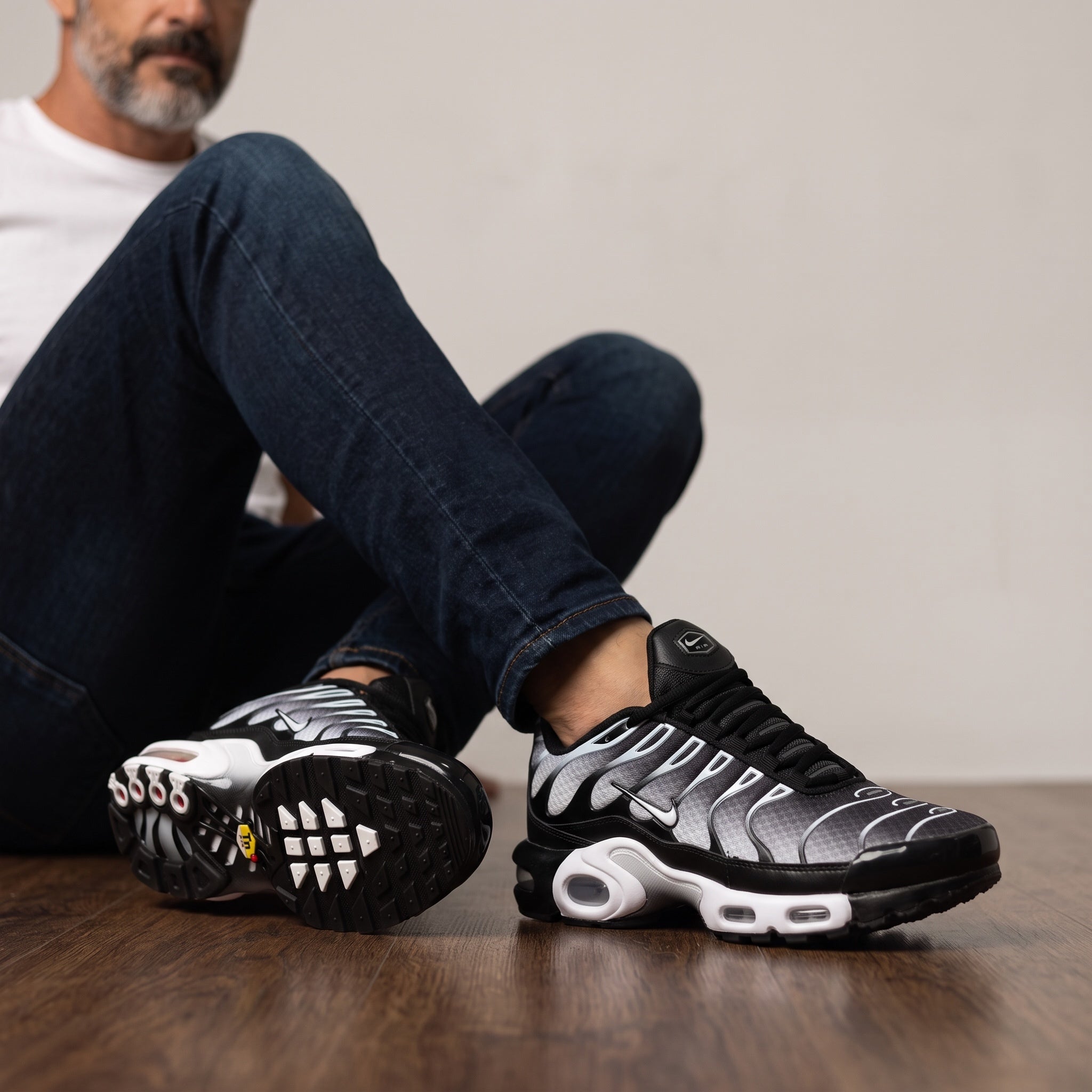 Nike Air Max Plus Tuned black gradient sneakers with visible Tuned Air pods
