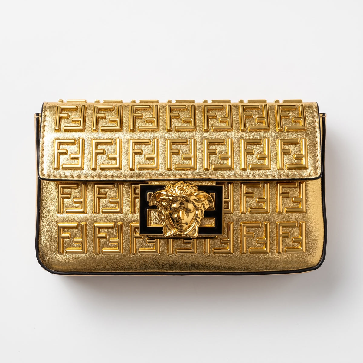 gold Fendi flap bag with embossed FF pattern and gold medallion clasp