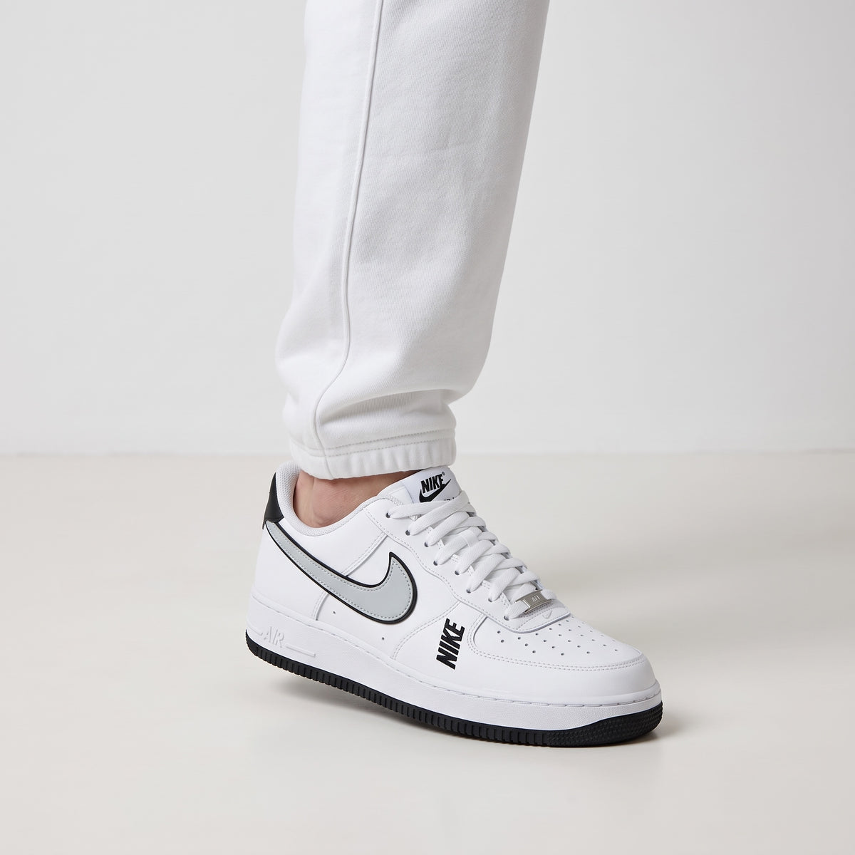 Nike Air Force 1 Low white sneaker with grey swoosh and black accents