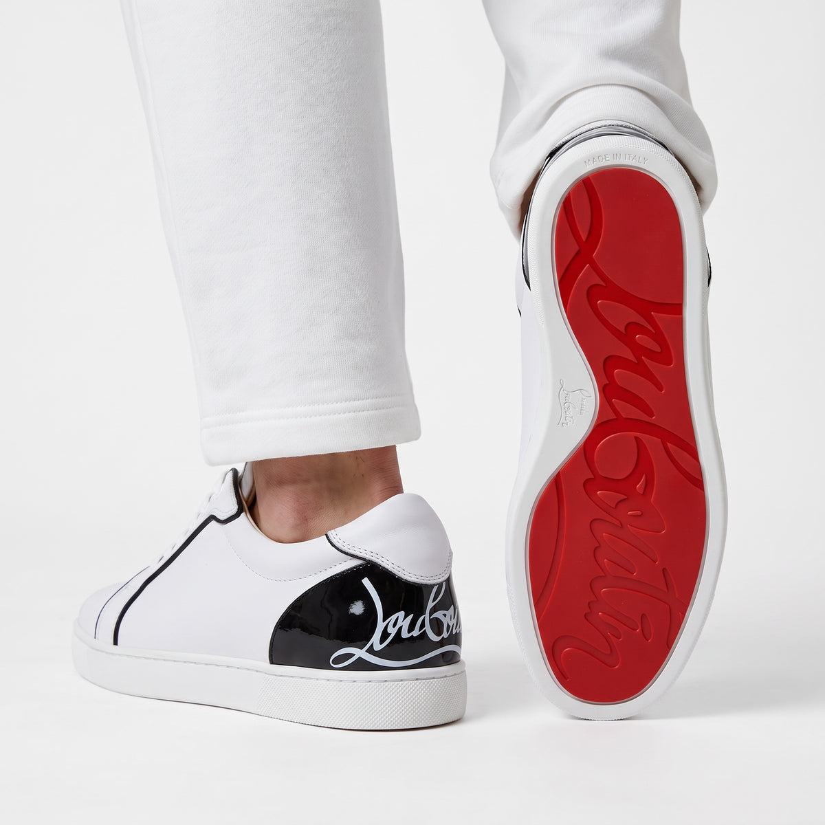 Christian Louboutin white low-top sneakers with black heel tab and red sole