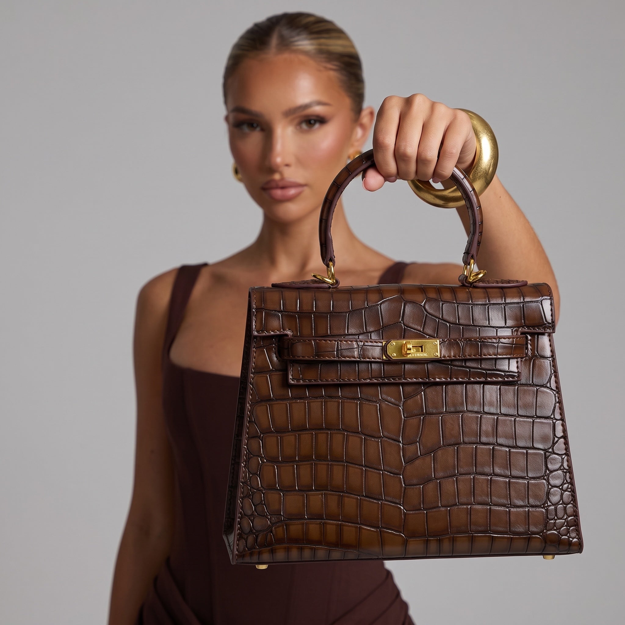 brown croc-embossed top-handle bag with gold turn-lock hardware