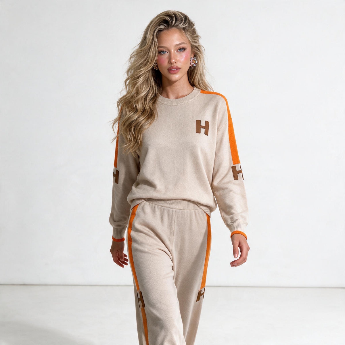 Beige knit two-piece tracksuit with orange side stripes and H logo patches