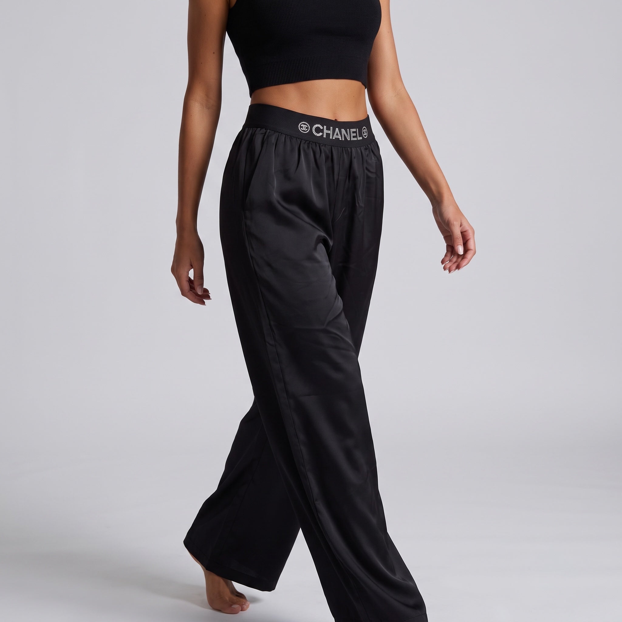 Black wide-leg trousers with high elastic waistband printed CHANEL logo in crystal dots