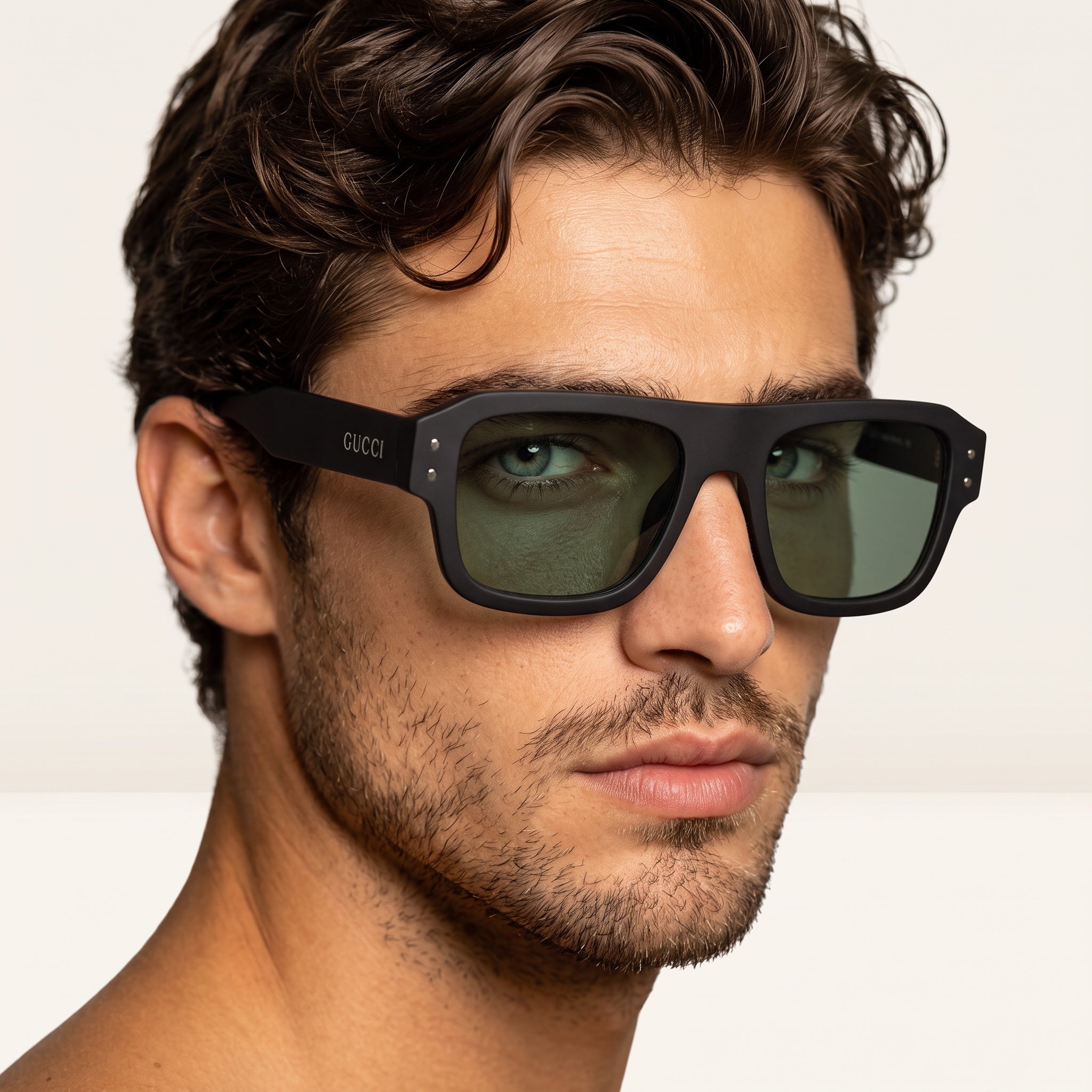 close-up of man wearing Gucci oversized matte black sunglasses with green lenses