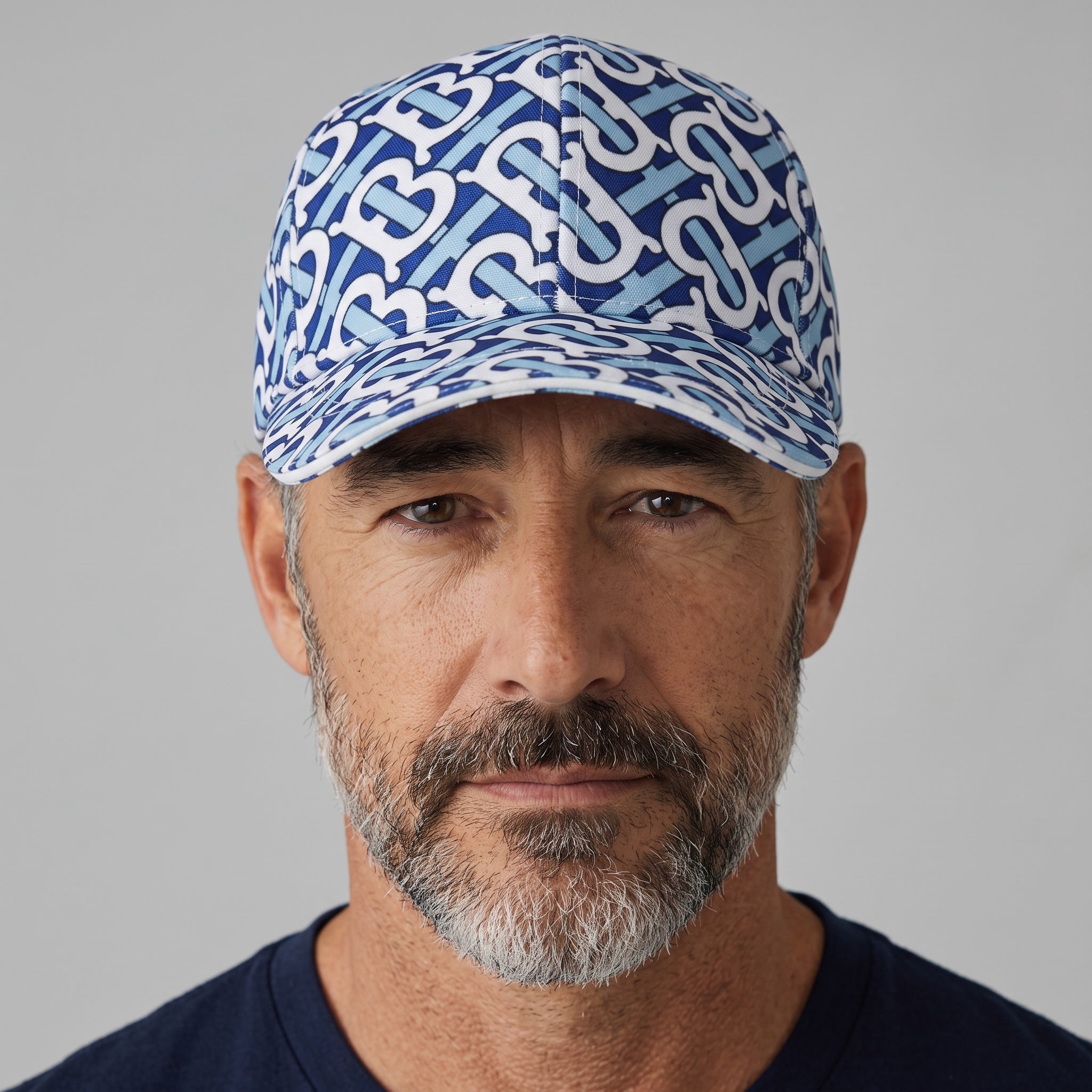 Man wearing a blue and white Burberry TB monogram print baseball cap