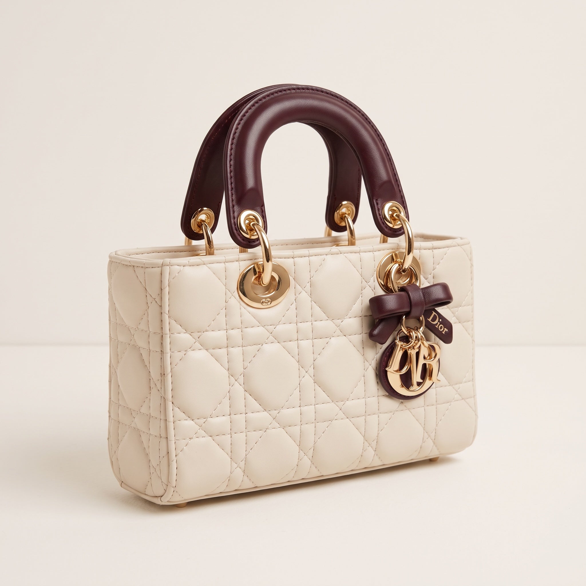 Cream quilted Dior Lady Dior tote with burgundy rolled handles and gold hardware
