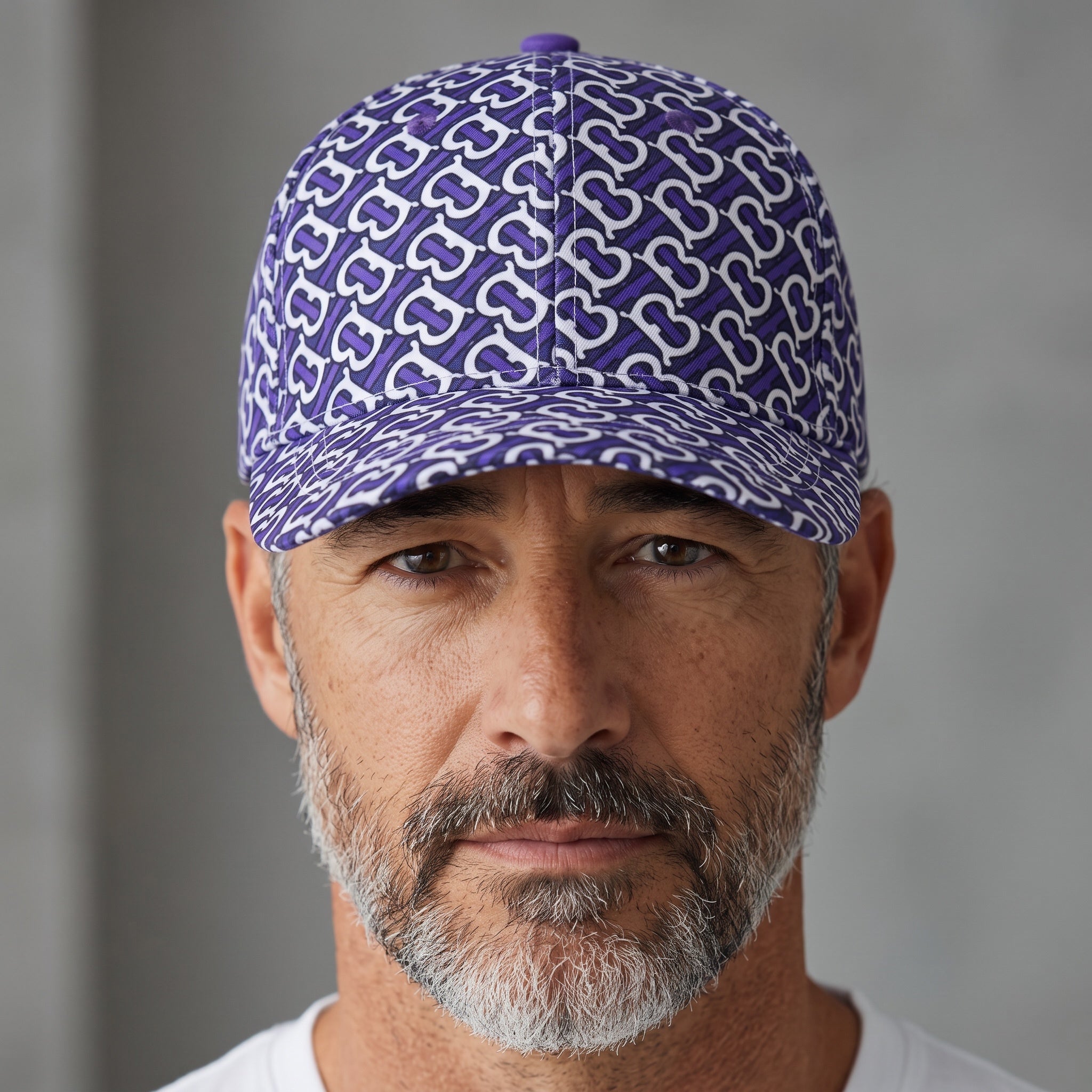 Man wearing a purple and white monogram print baseball cap