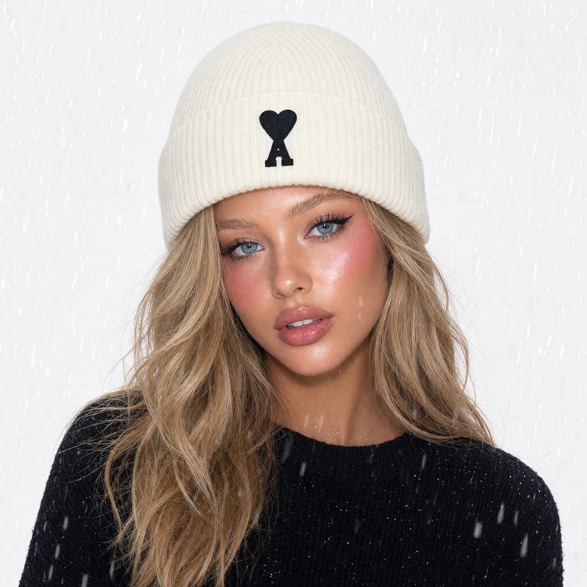 Ivory ribbed AMI beanie with black Ami de Coeur logo on front
