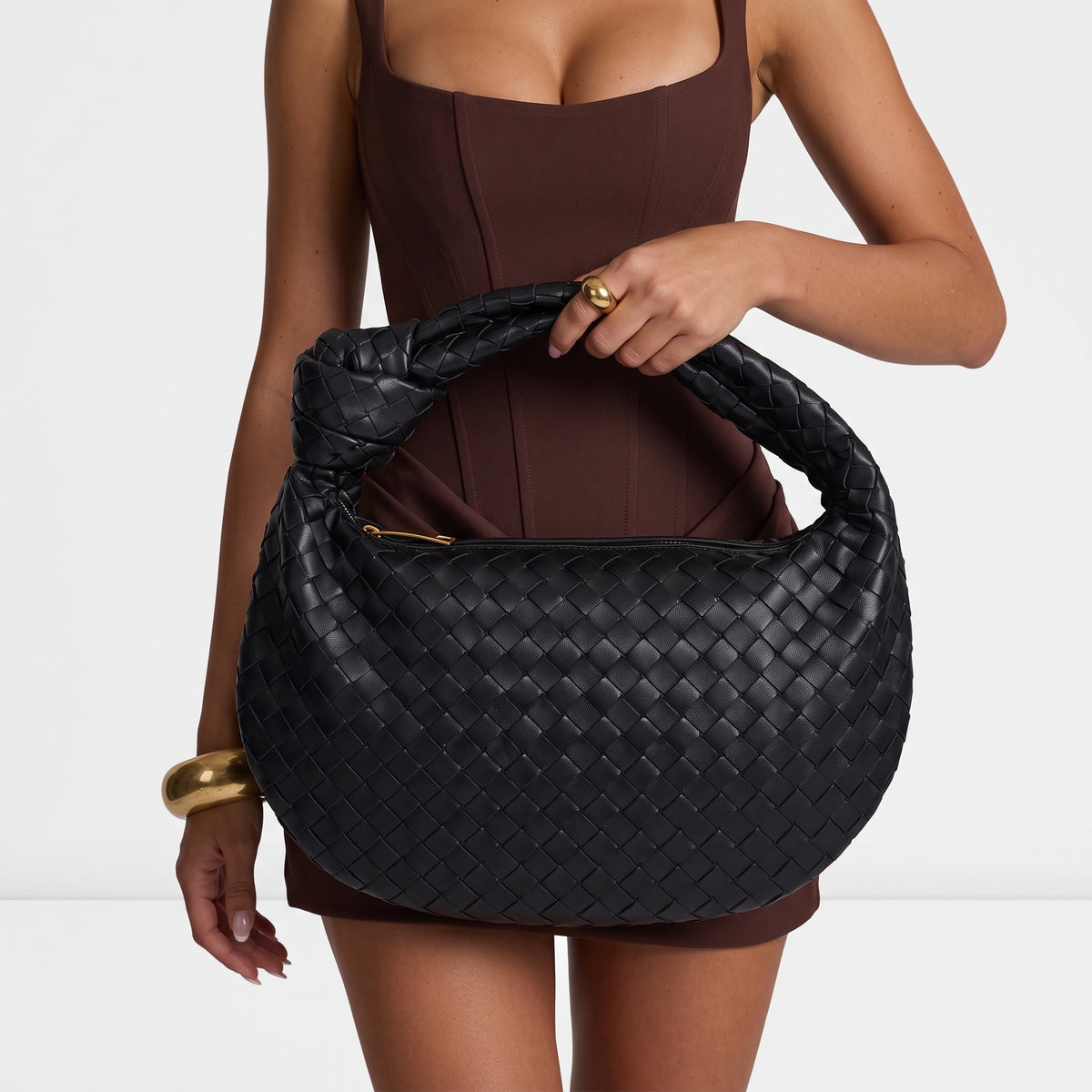Black woven intrecciato hobo bag with knotted top handle and gold zipper