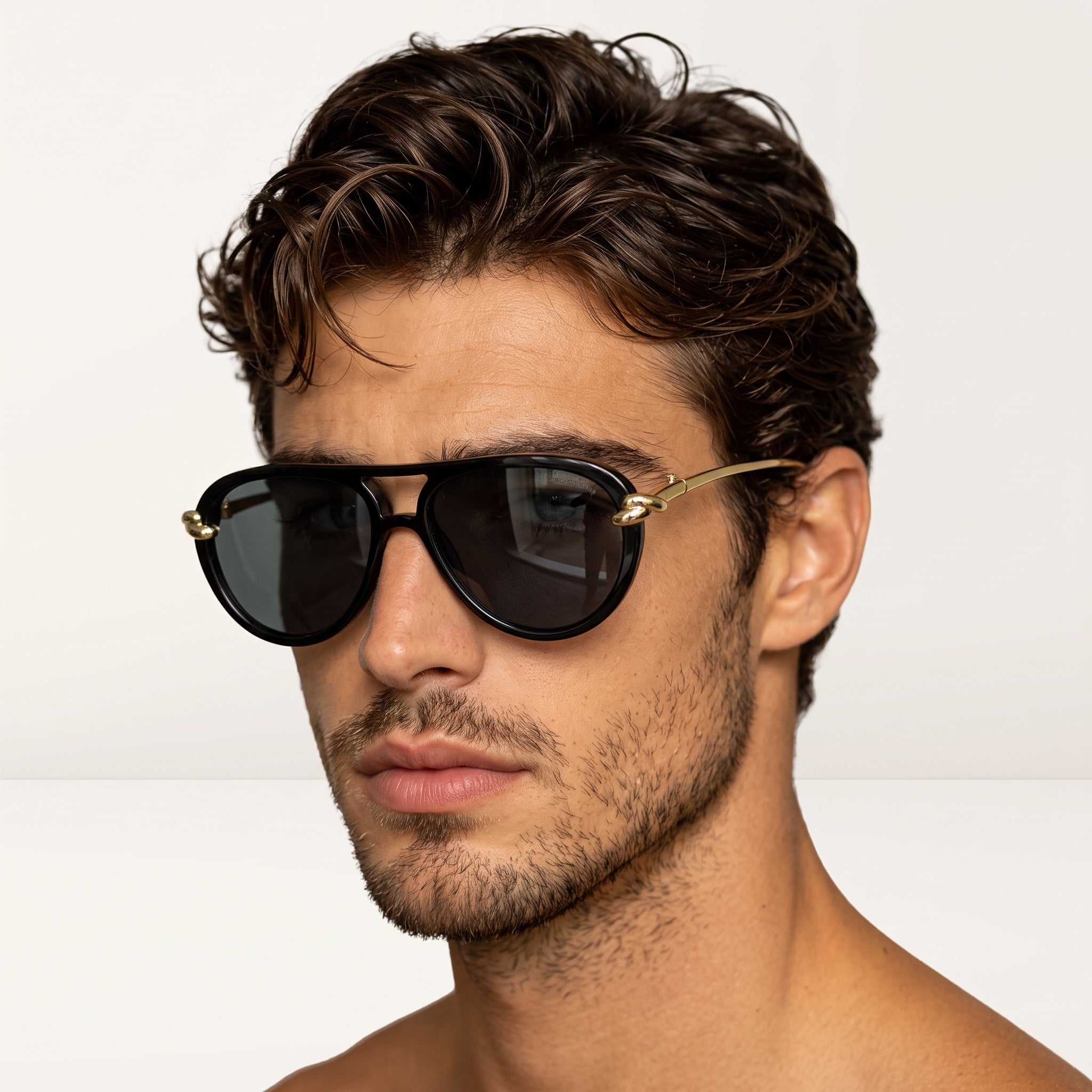 close-up of man wearing black sunglasses with gold temples