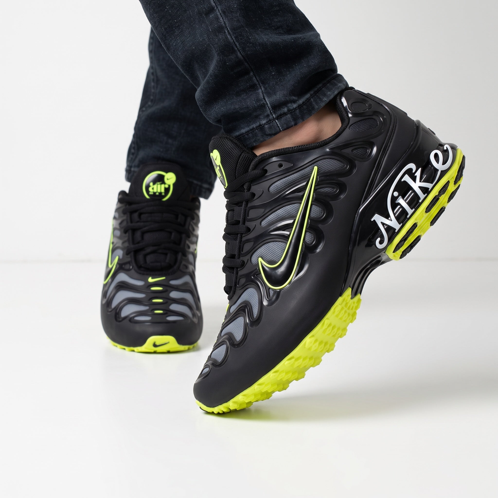 Black Nike Air Max sneaker with neon volt accents and sculpted overlays