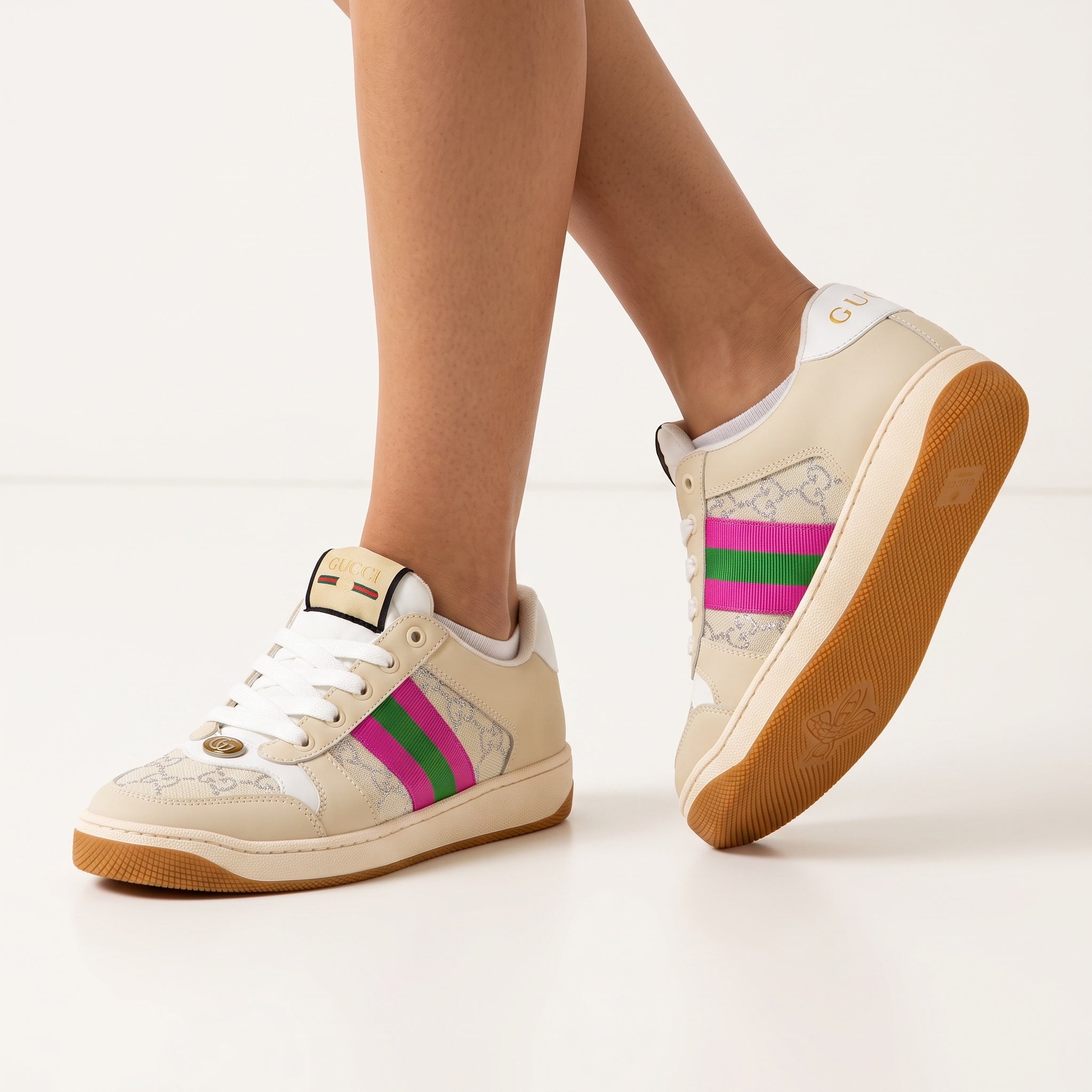 Beige Gucci low-top sneaker with pink and green web stripe and gum sole