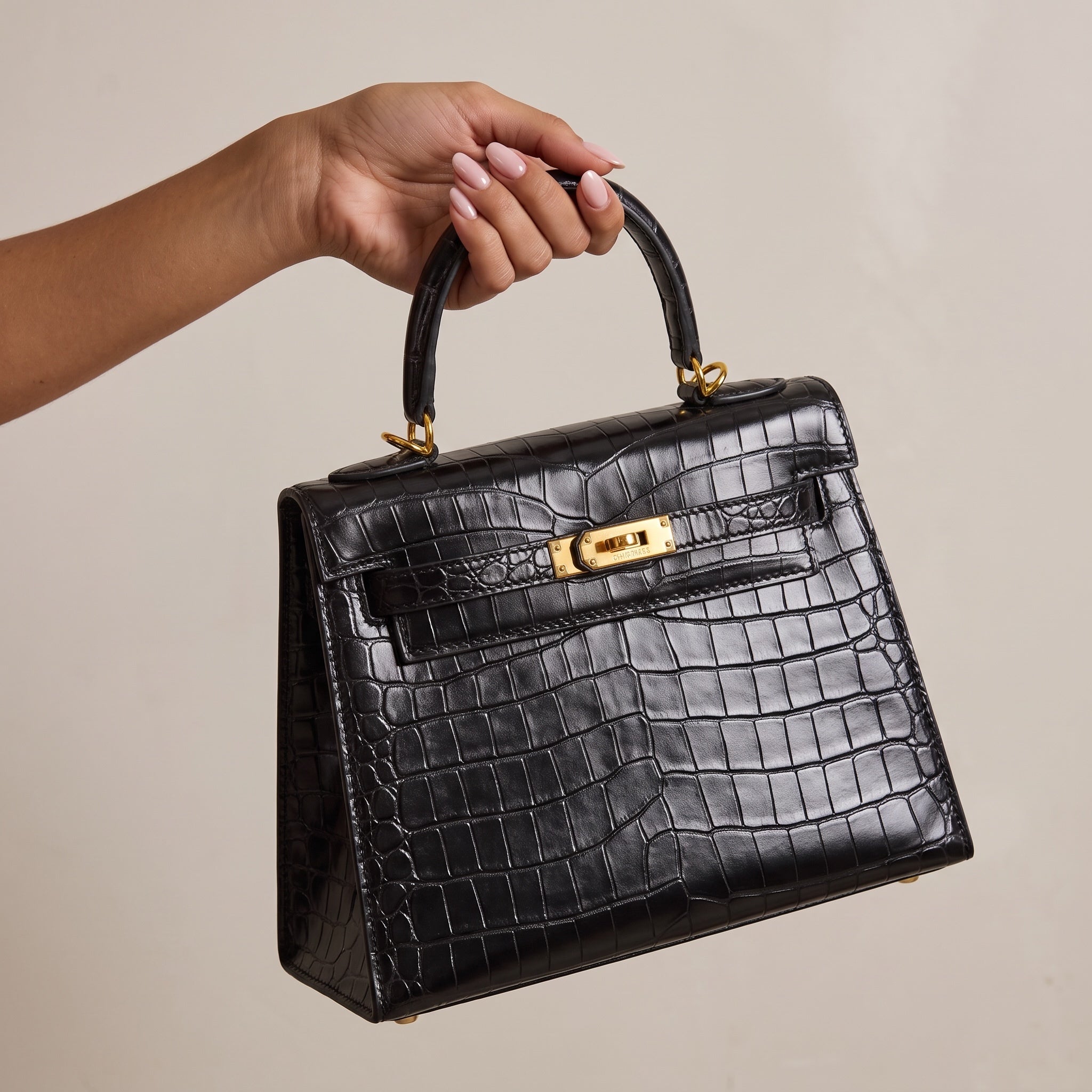 Black croc-embossed top-handle tote with gold turn-lock hardware