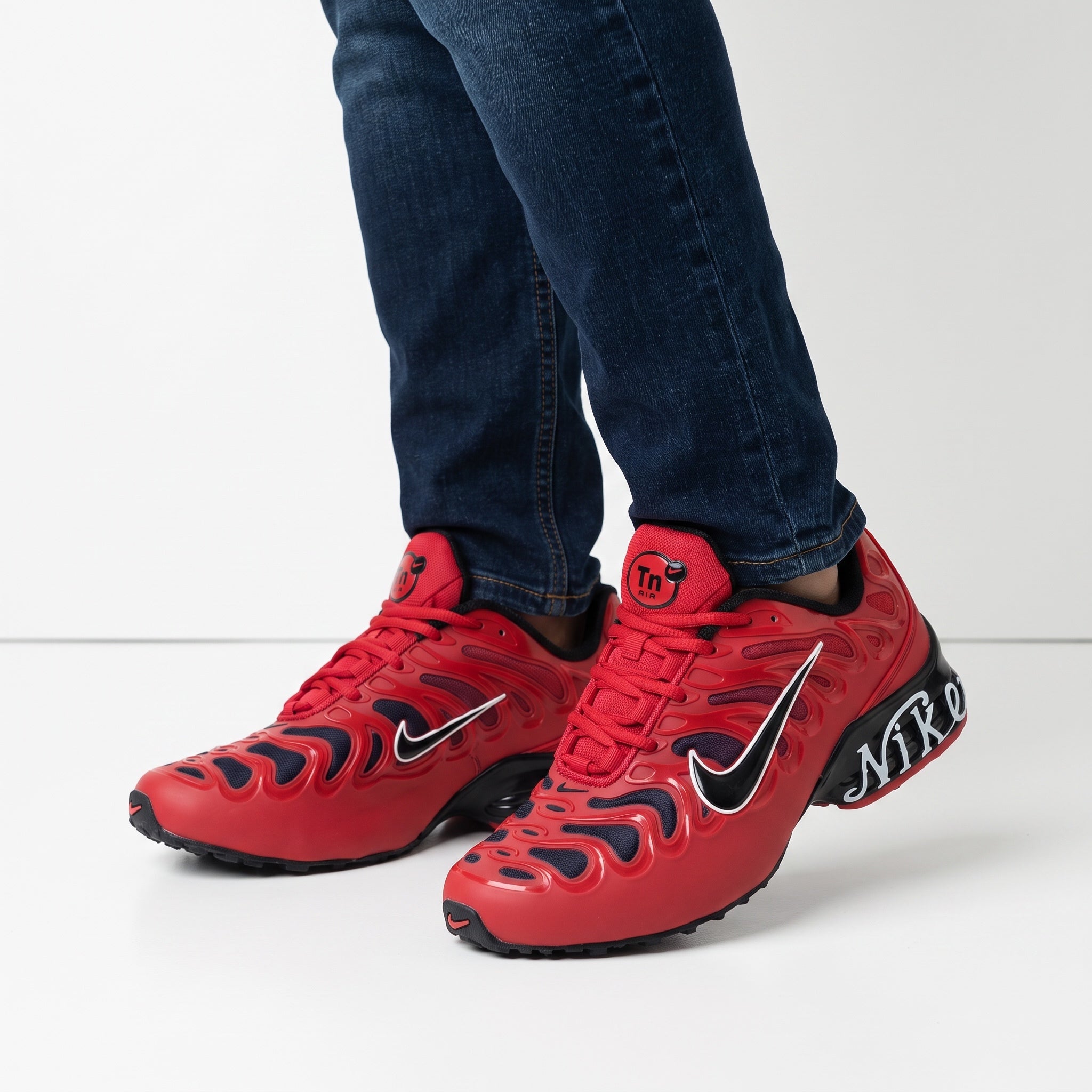 red Nike Tuned TN sneakers with black midsole and white Swoosh