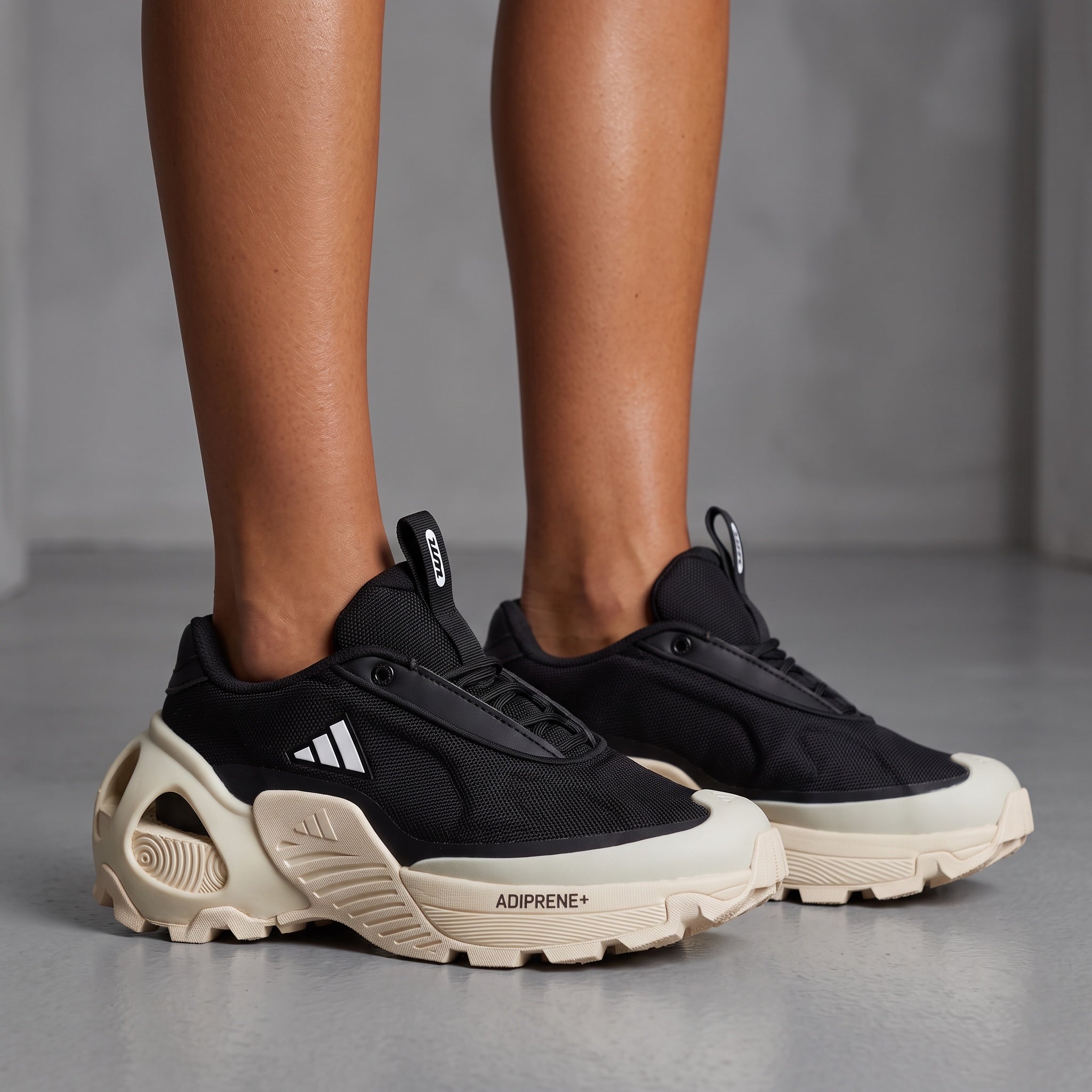 Black Adidas chunky sneakers with cream sculpted sole and ADIPRENE+ text