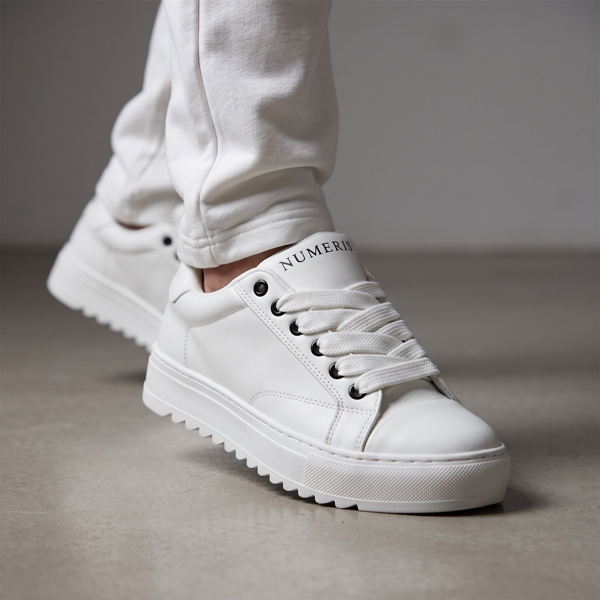 white Numeris platform sneakers with lug sole and black eyelets