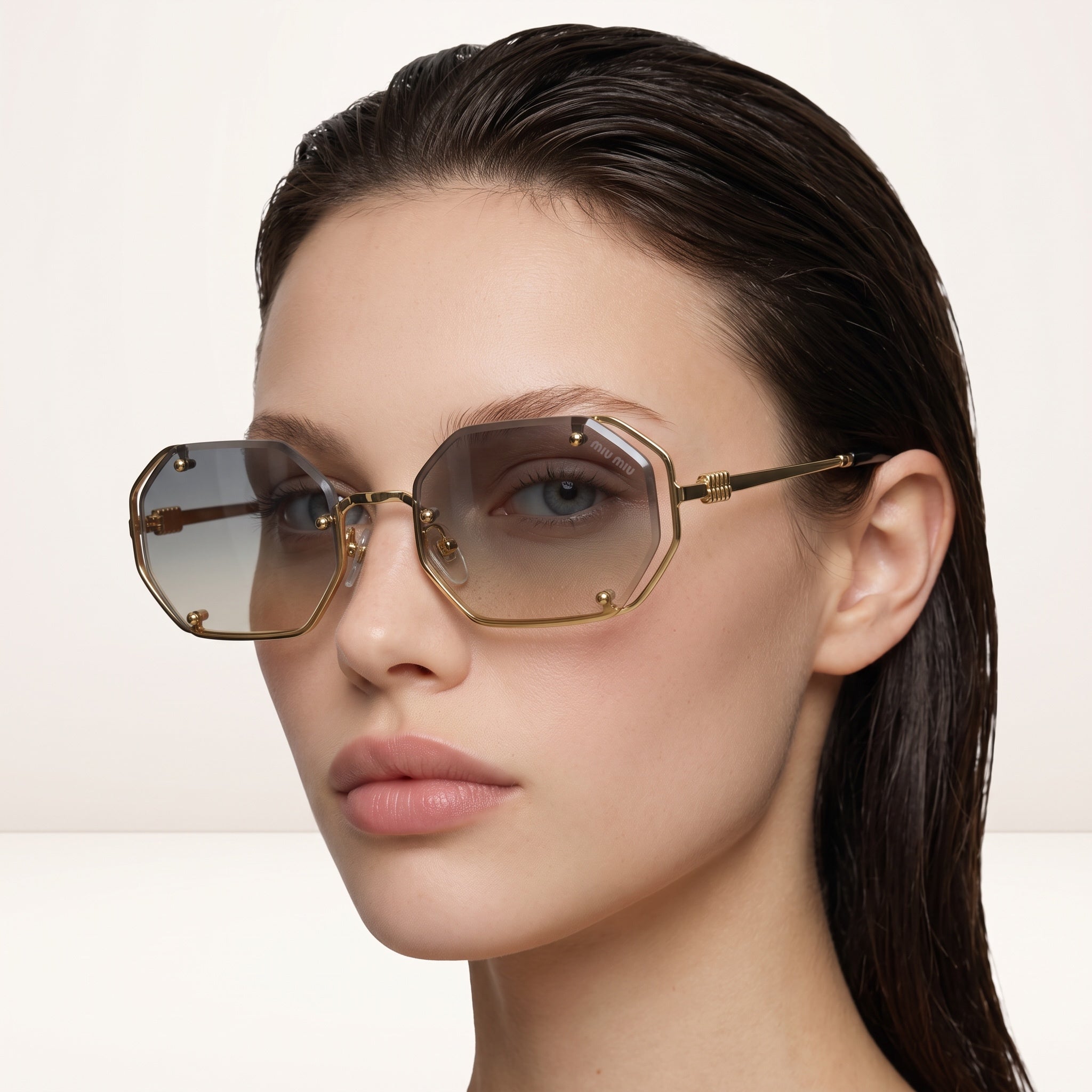 Miu Miu gold hexagonal sunglasses with gradient brown lenses on model
