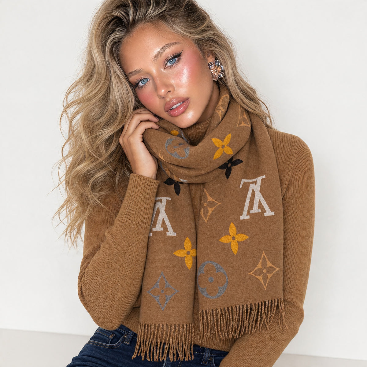 brown Louis Vuitton monogram scarf with fringe draped around model neck