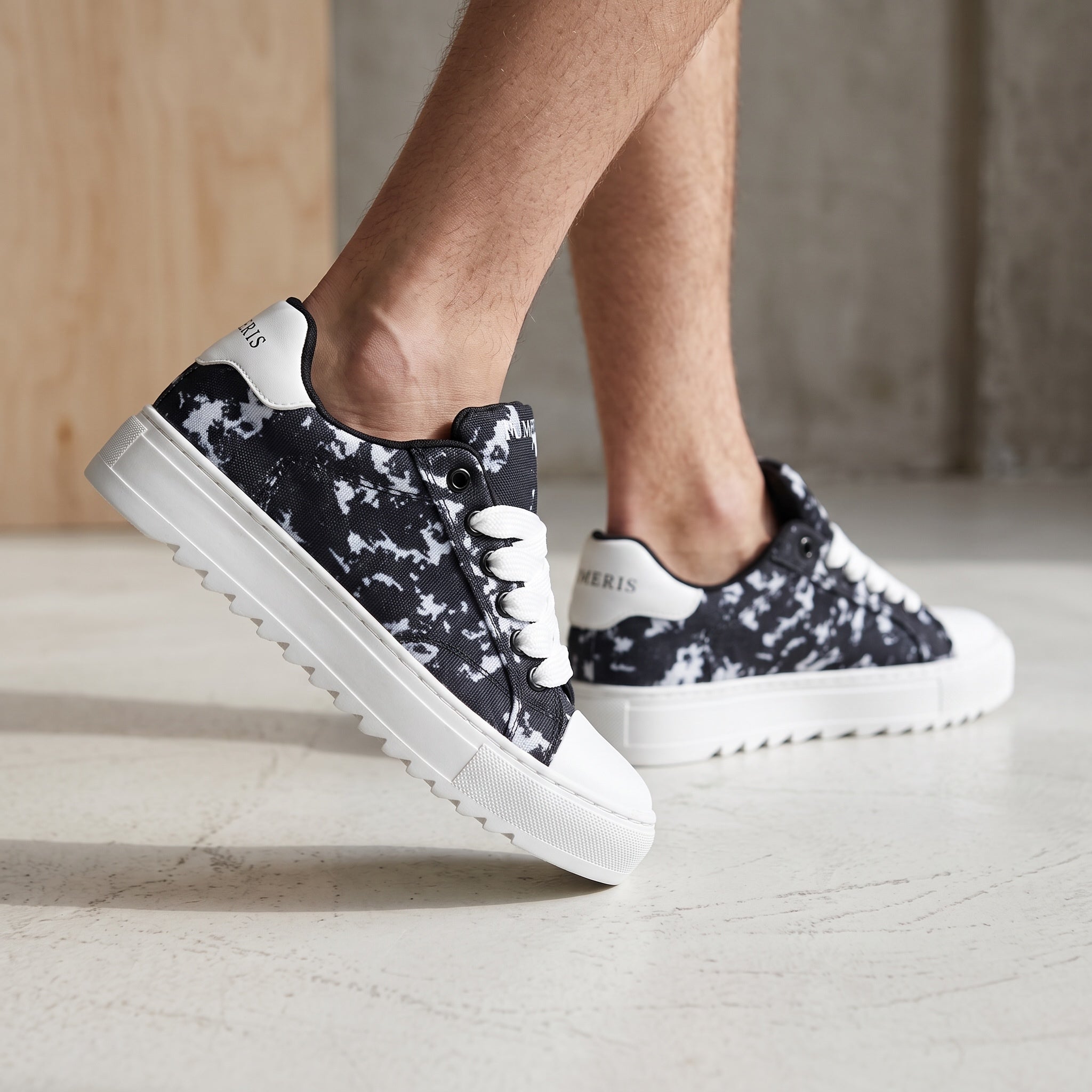 Numeris black and white marble low-top sneakers with chunky white platform sole