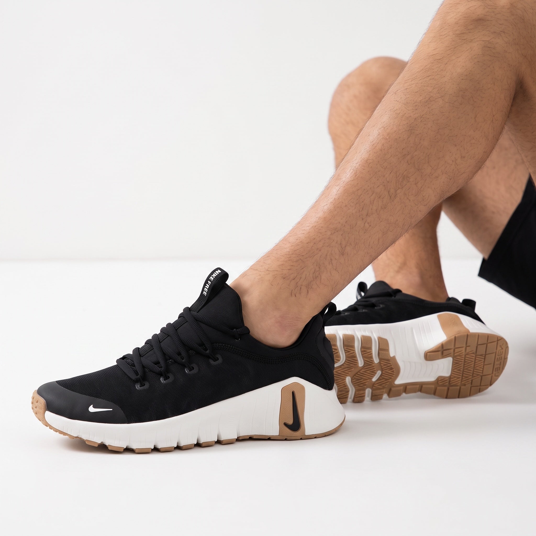 black Nike Free trainer with white midsole and gum outsole