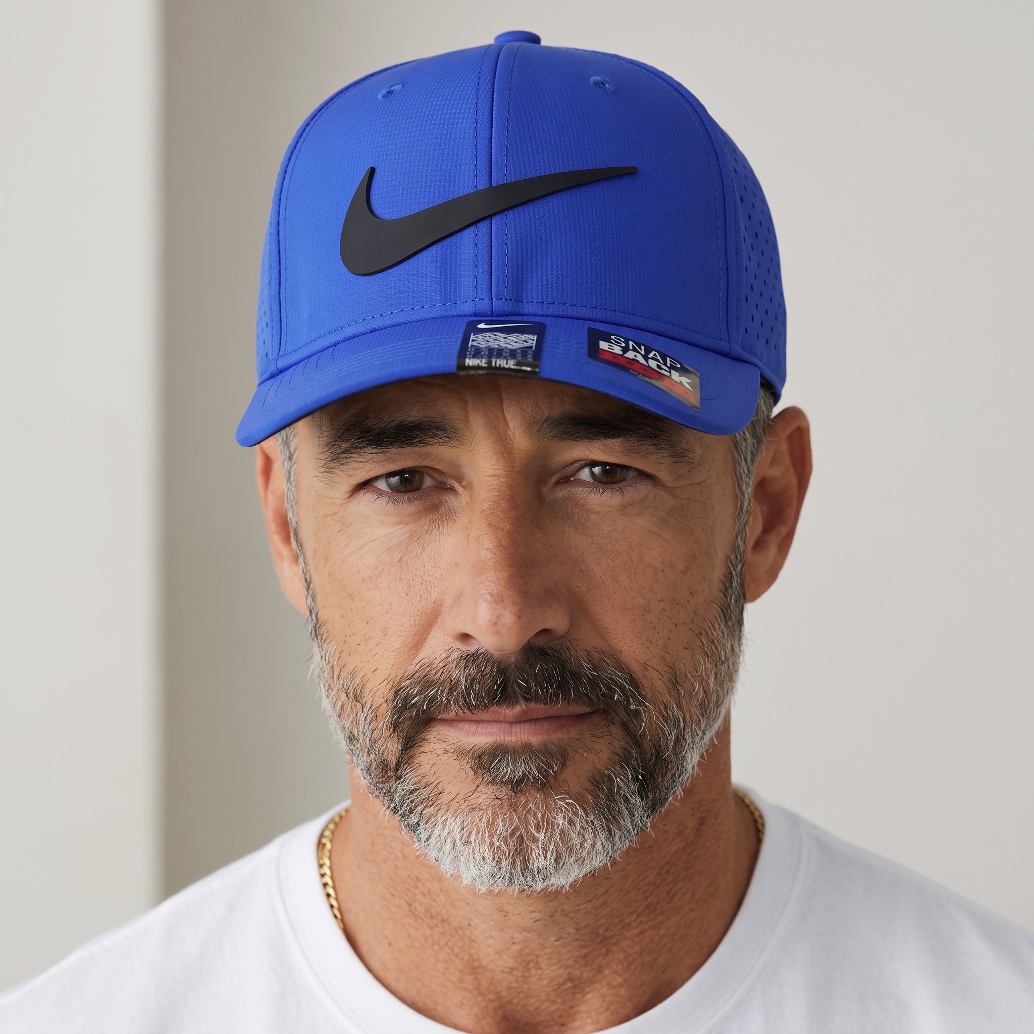 Man wearing a royal blue Nike snapback cap with black swoosh logo