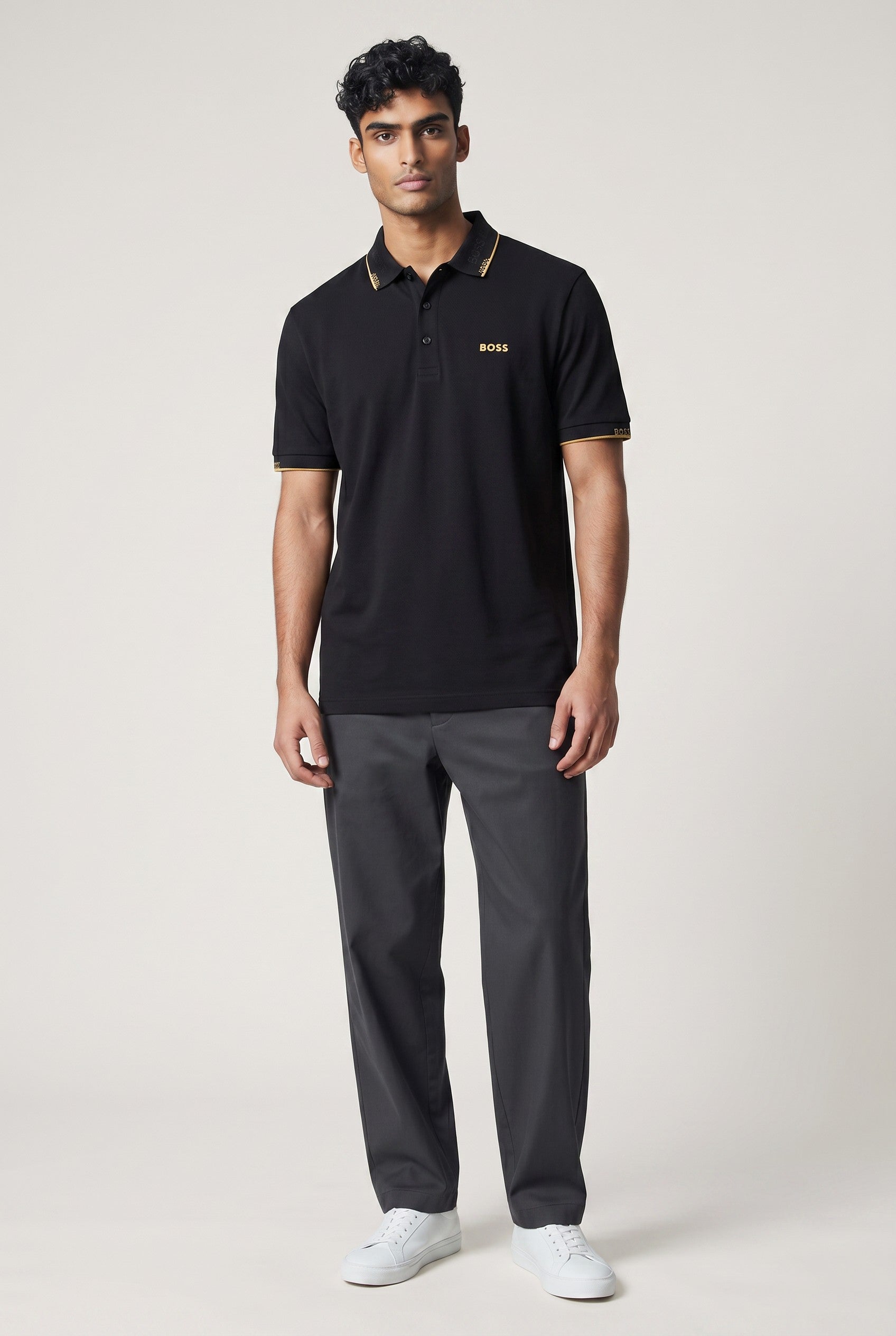 MASTERPIECE BOSS black polo shirt with gold collar detail and chest logo. Smooth fabric, tailored fit.