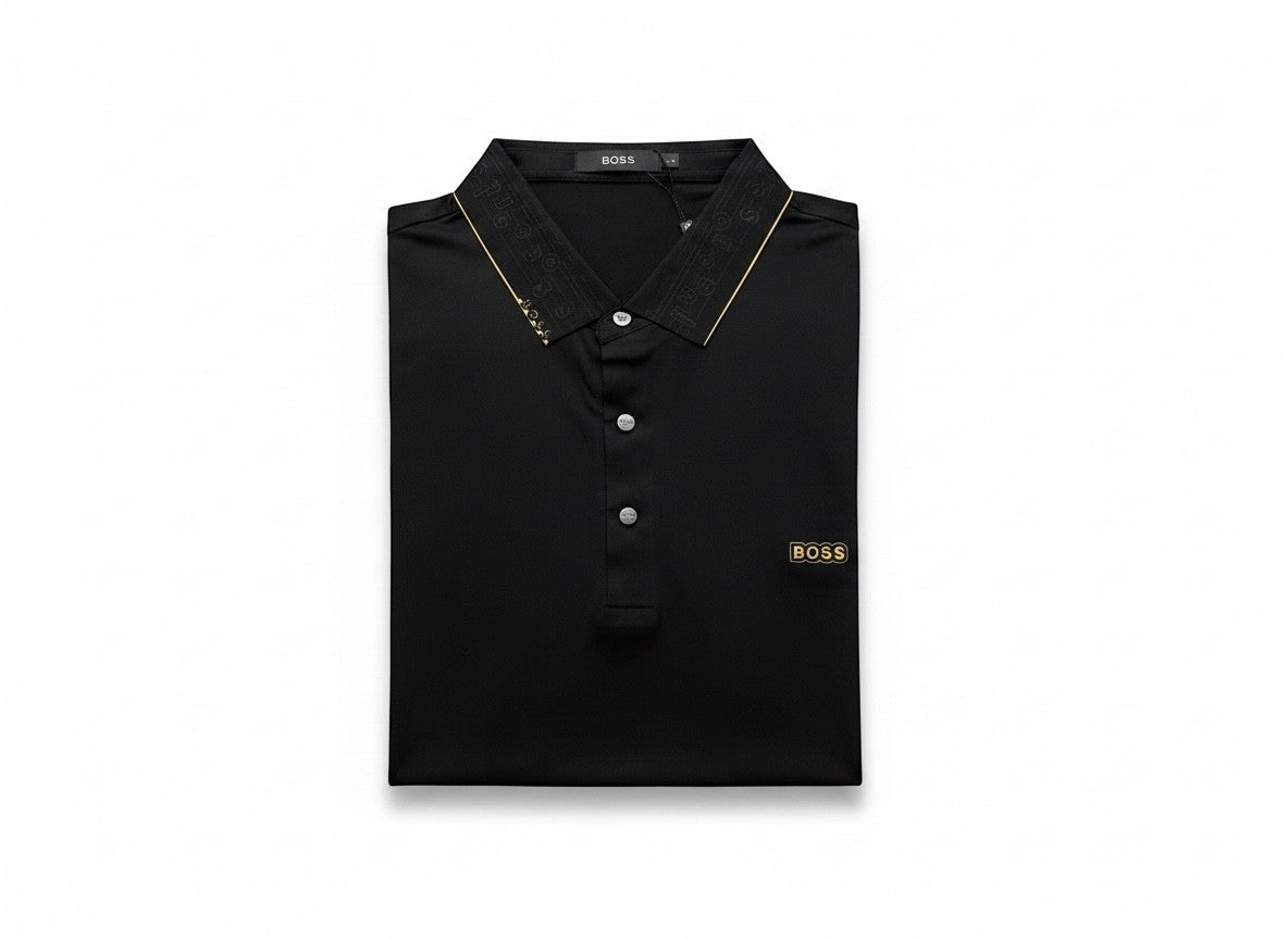 MASTERPIECE BOSS black polo shirt with gold BOSS logo on chest and gold detailing on collar. Smooth breathable fabric, tailored fit.