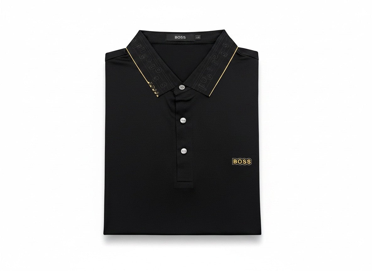 MASTERPIECE BOSS black polo shirt with gold BOSS logo on chest and gold trim on collar. Tailored fit, breathable fabric.