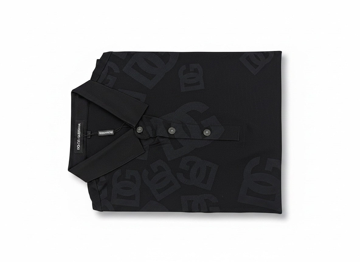 MASTERPIECE black Dolce & Gabbana polo shirt with all-over DG monogram print and classic collar.