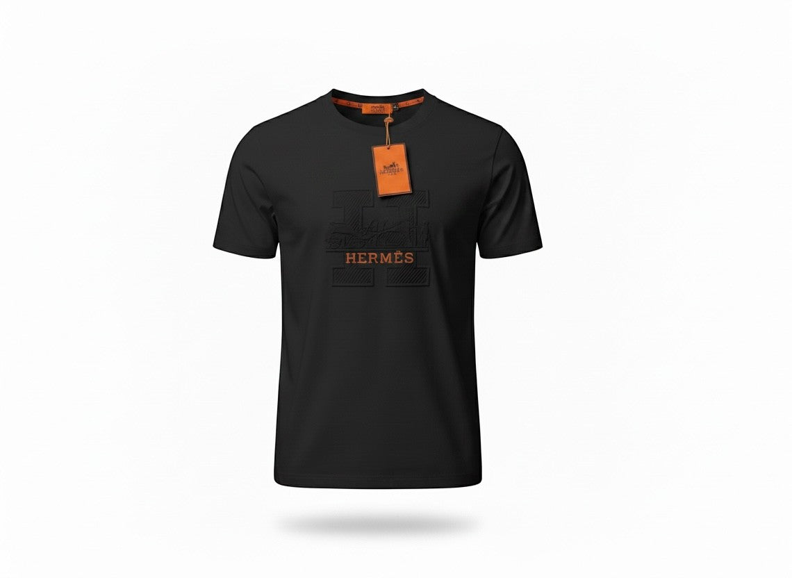 MASTERPIECE black cotton t-shirt with embossed Hermès H logo and orange tag detail. Crew neck, premium fit.